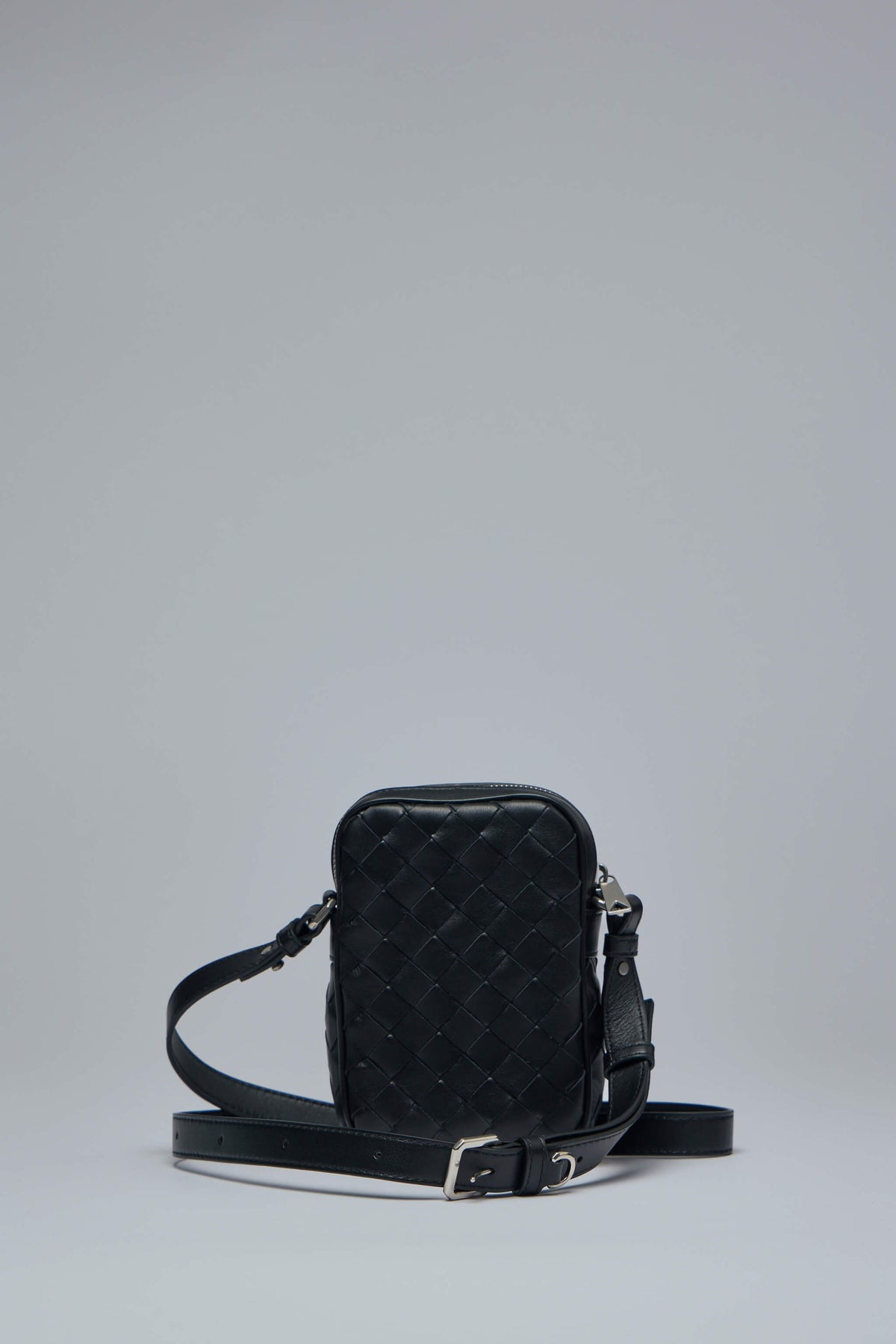 Side view showing adjustable strap and compact silhouette of luxury crossbody bag