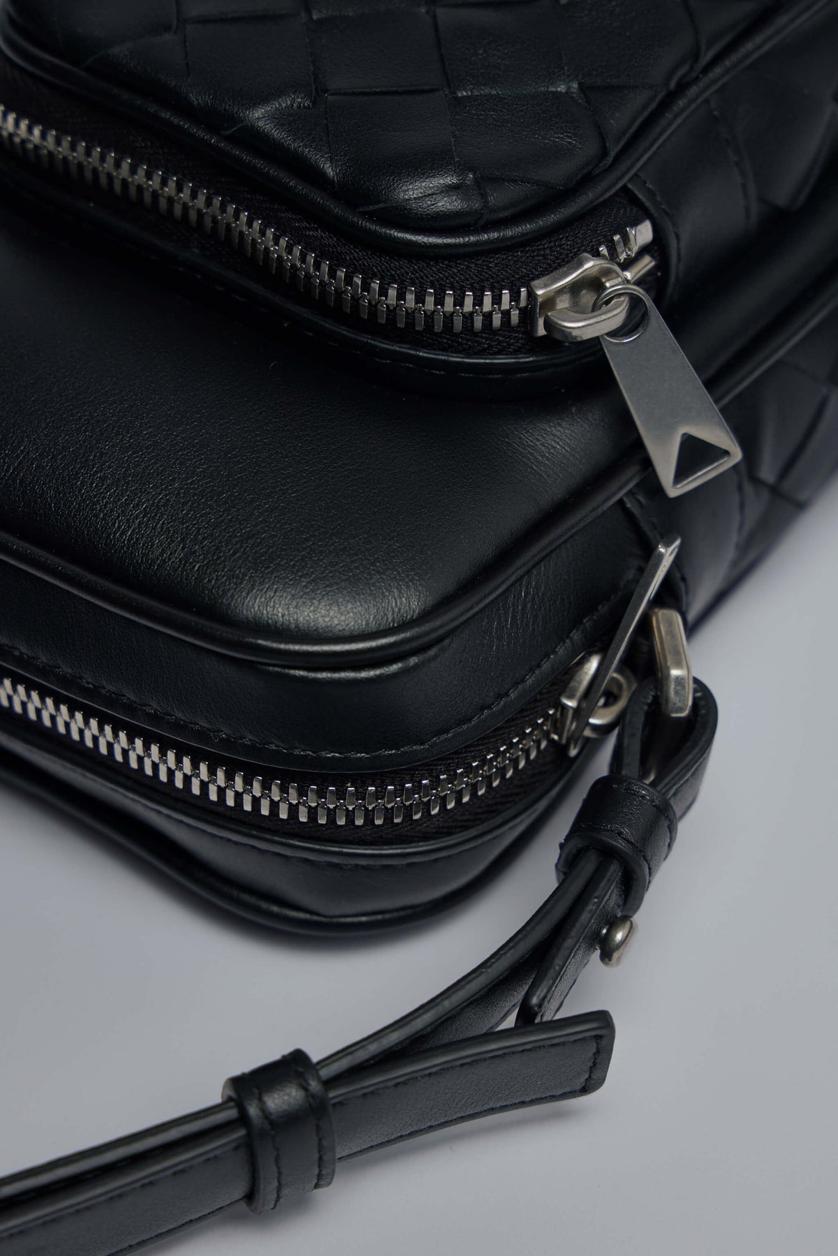Styled image of Bottega Veneta crossbody bag worn across body