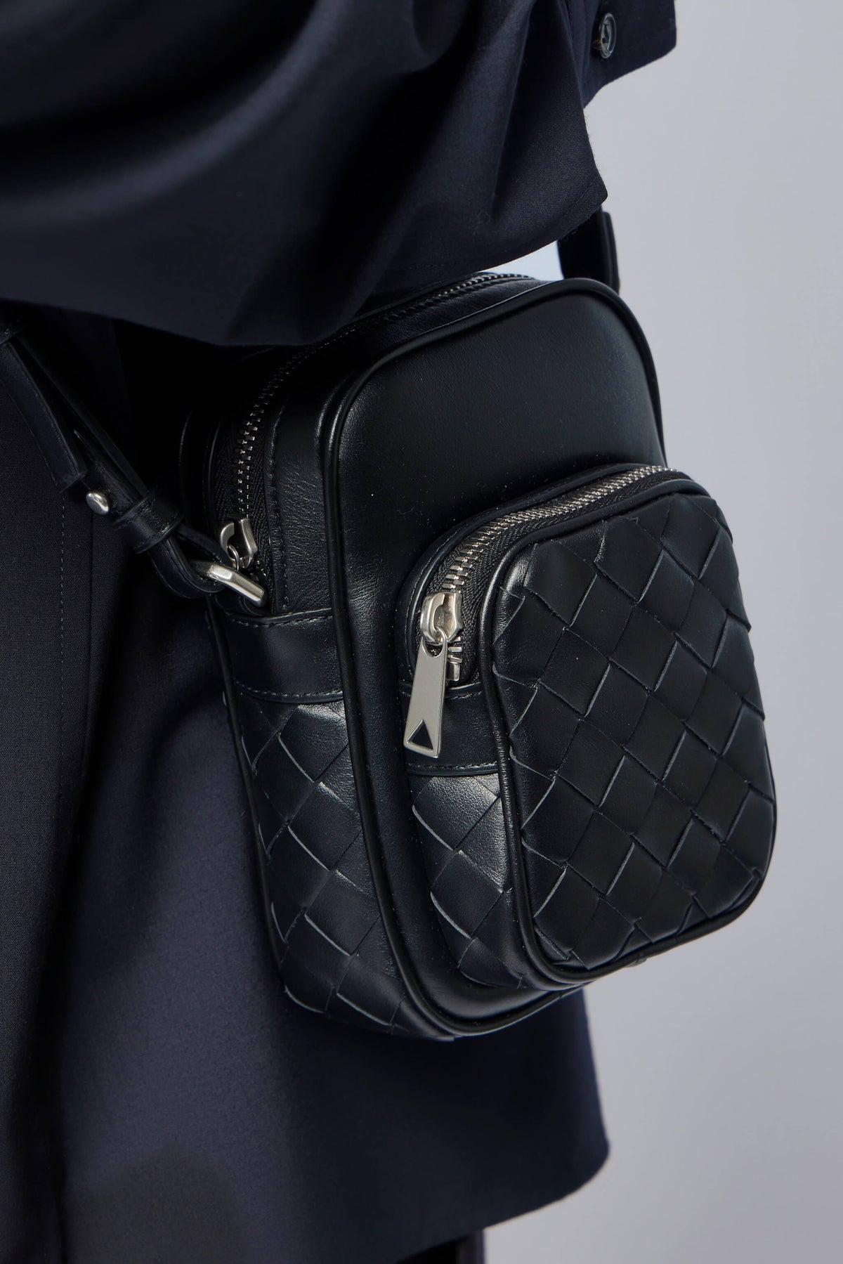 Detail shot of silver-tone hardware and zip closure on Italian leather bag