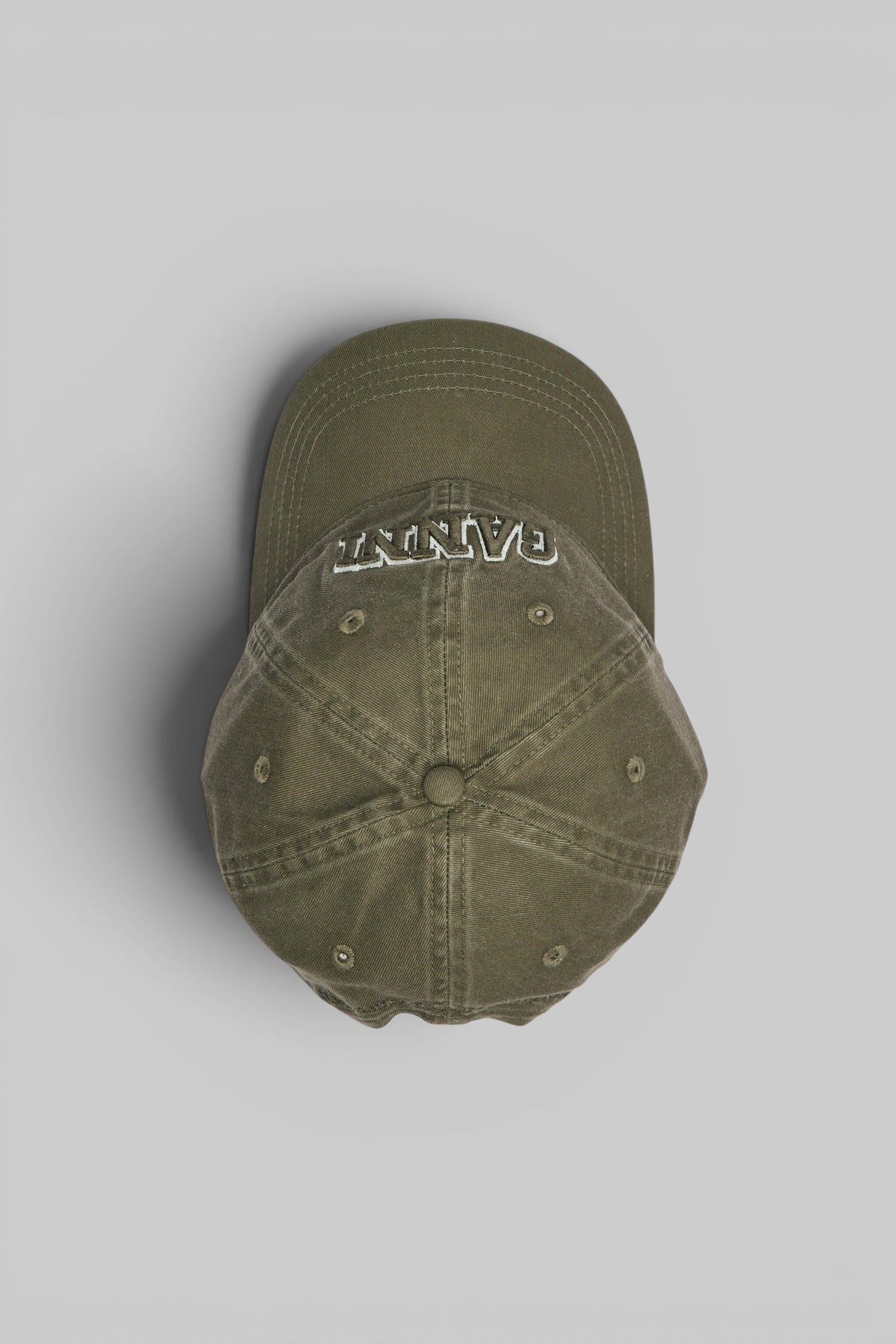 Side profile of washed cotton canvas cap by Ganni