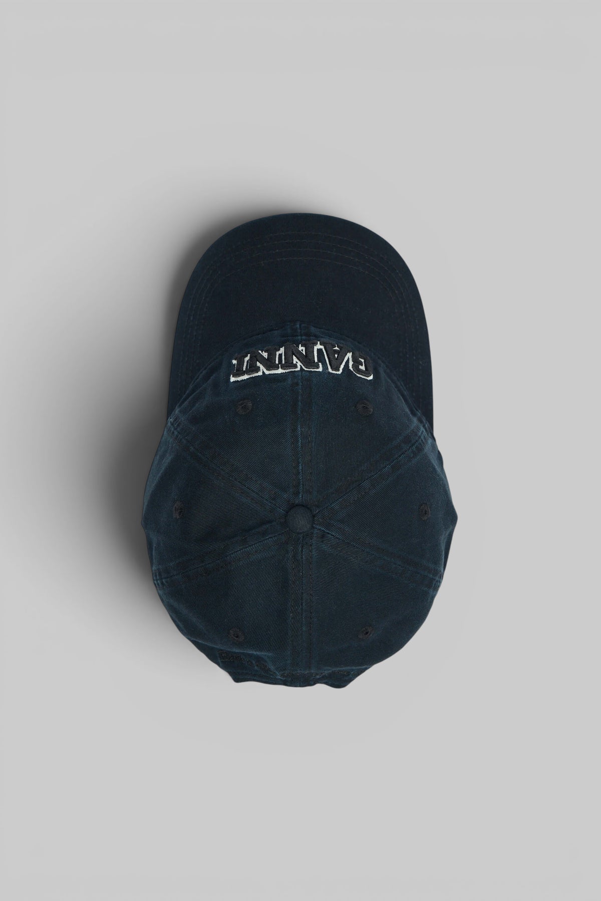Side view of Ganni washed cotton canvas cap showing adjustable strap