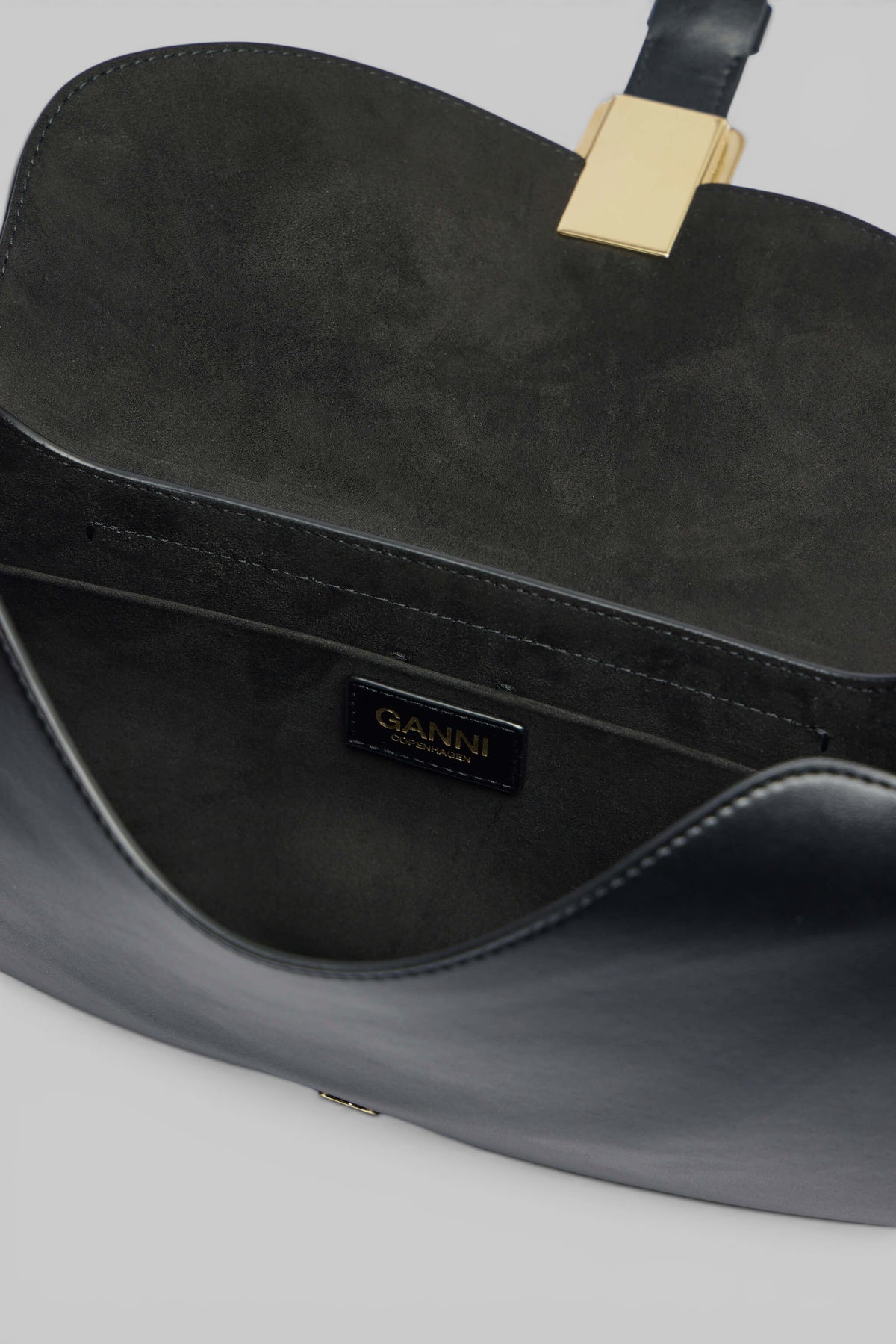 Ganni B-Kat bag flat lay showing compact crossbody design