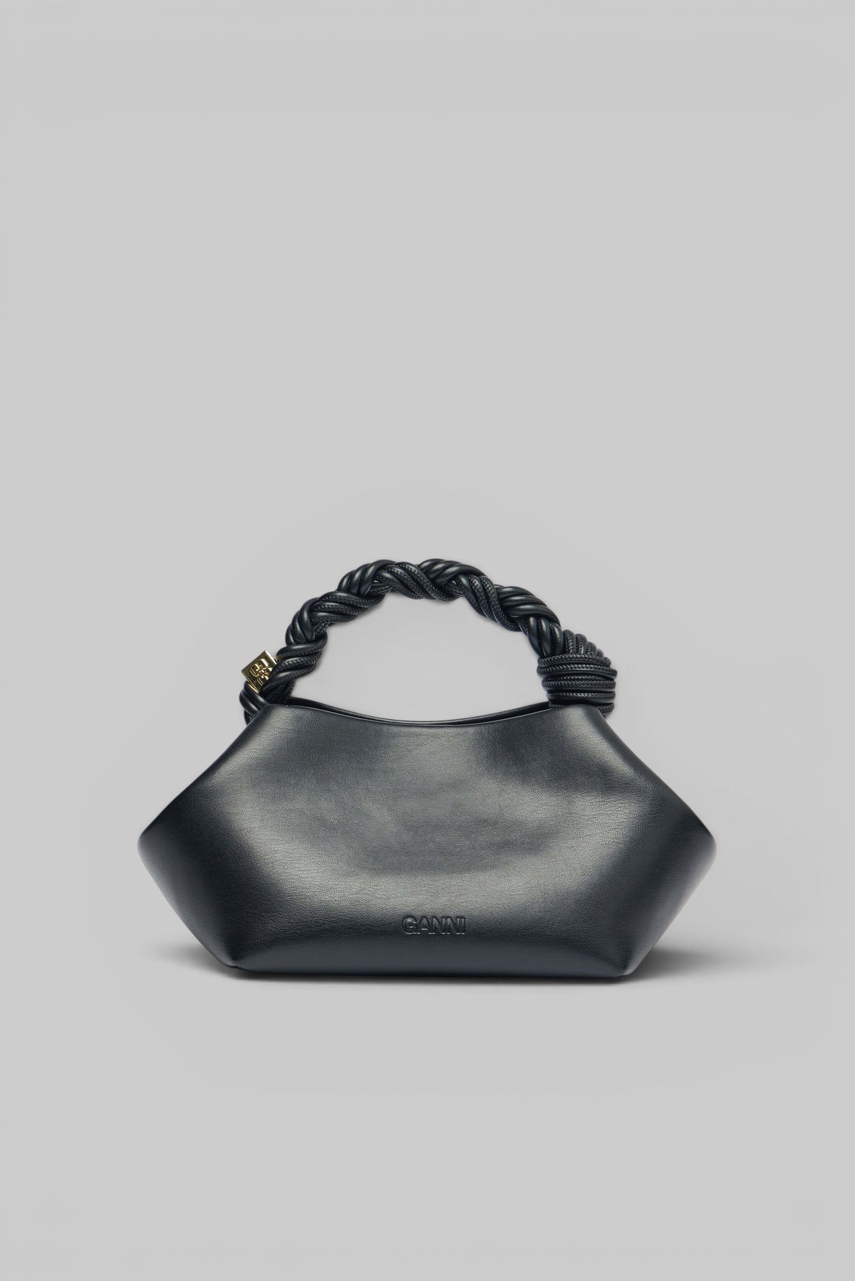 Detail shot of twisted handle on Ganni designer clutch
