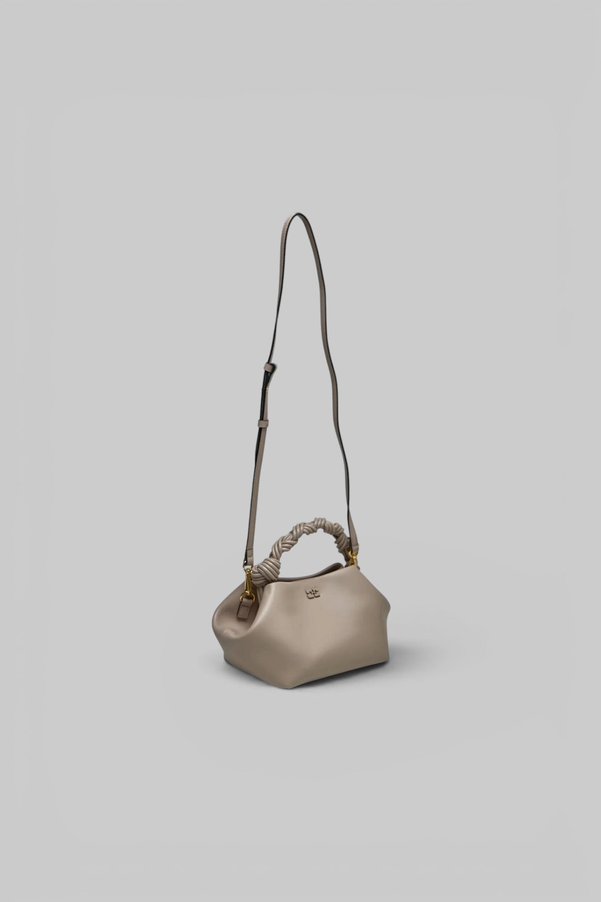 Model carrying Ganni Bou Bag with removable 50cm shoulder strap