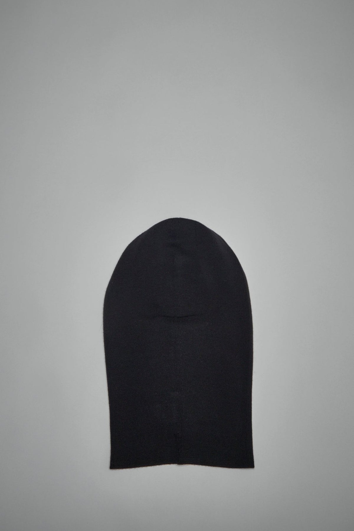 Model wearing black Acne Studios wool balaclava with face opening