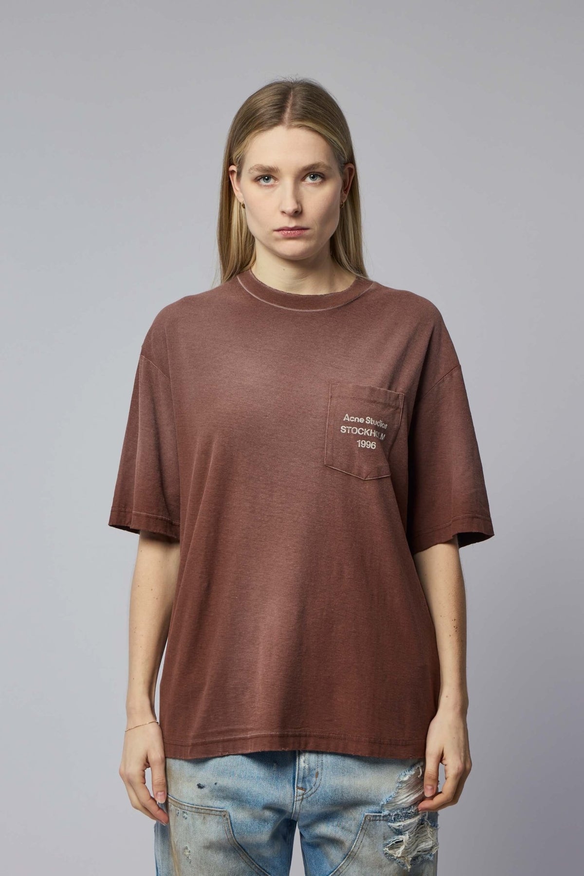 Close-up of Acne Studios branded chest pocket detail on cotton t-shirt