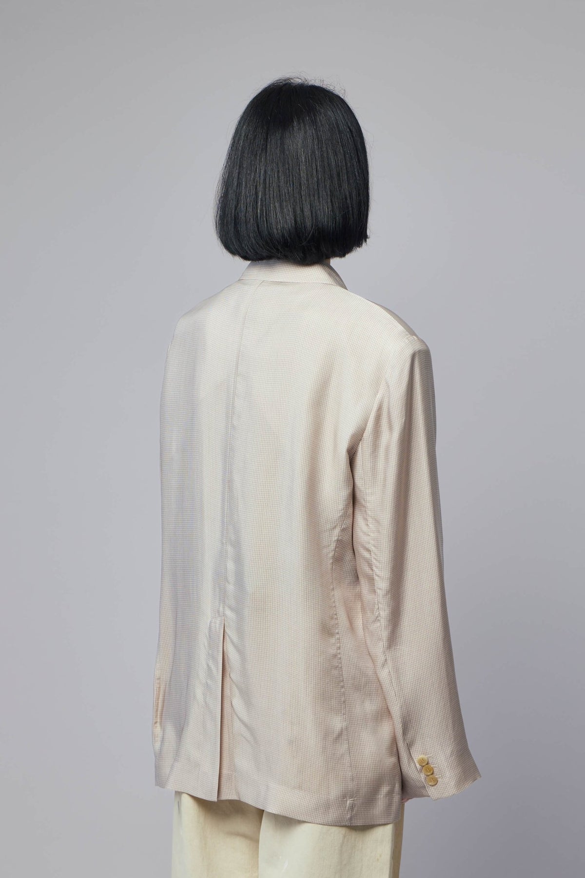 Back view of blazer highlighting contemporary design elements