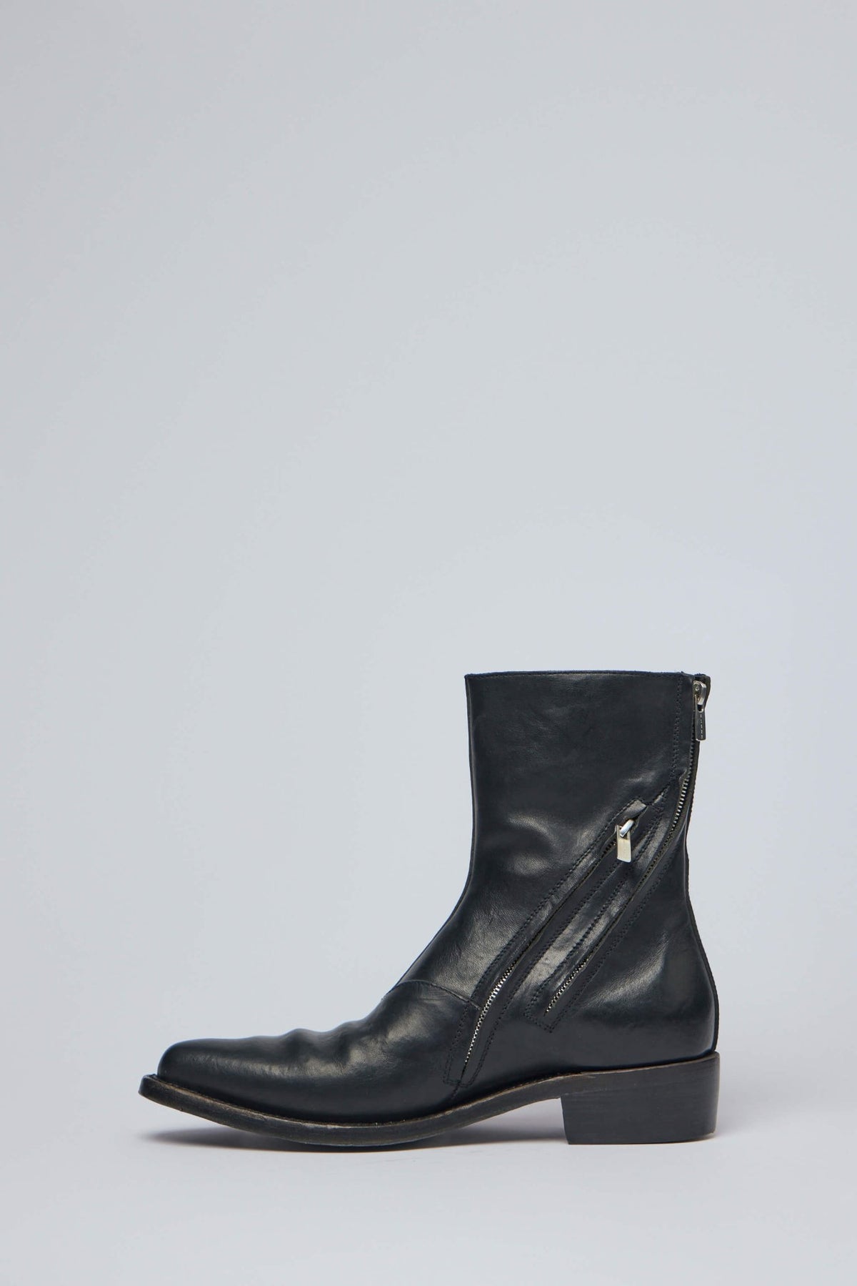 Side profile showing sleek silhouette and low stacked heel detail