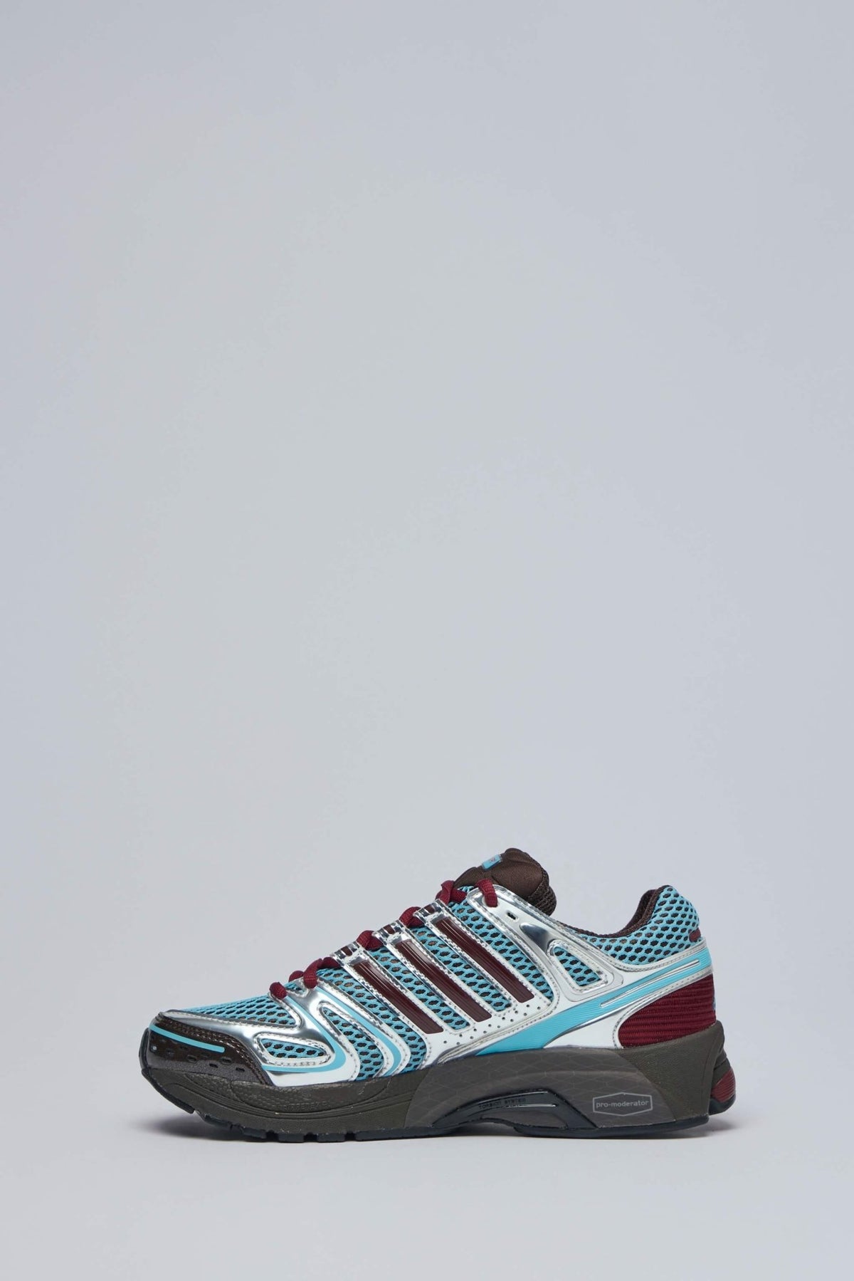 Close-up of Adidas logo on tongue and heel of Control 5 W sneakers