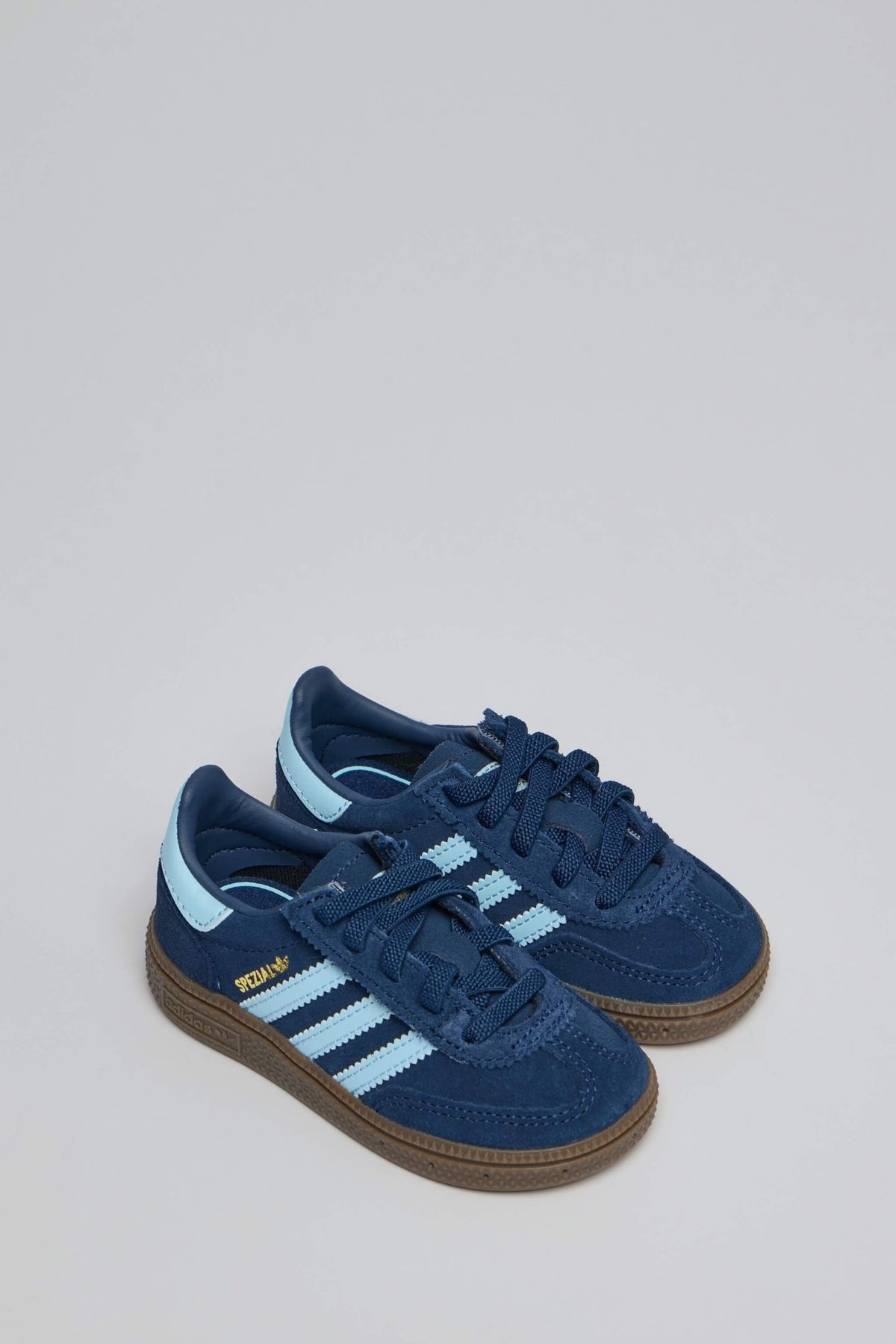 Side view of blue suede Handball Spezial CF sneakers showing textured brown sole