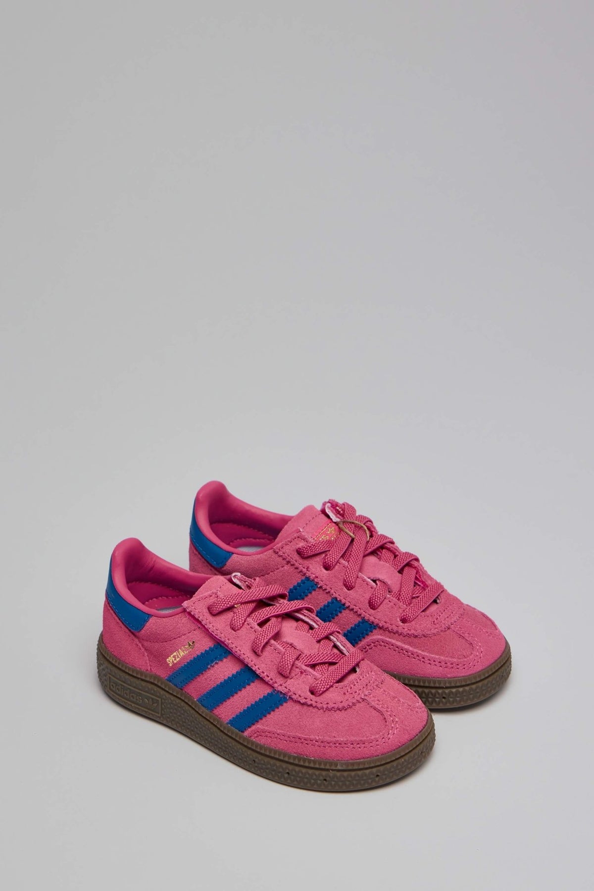 Side view of pink and blue Handball Spezial CF sneakers showing textured brown sole