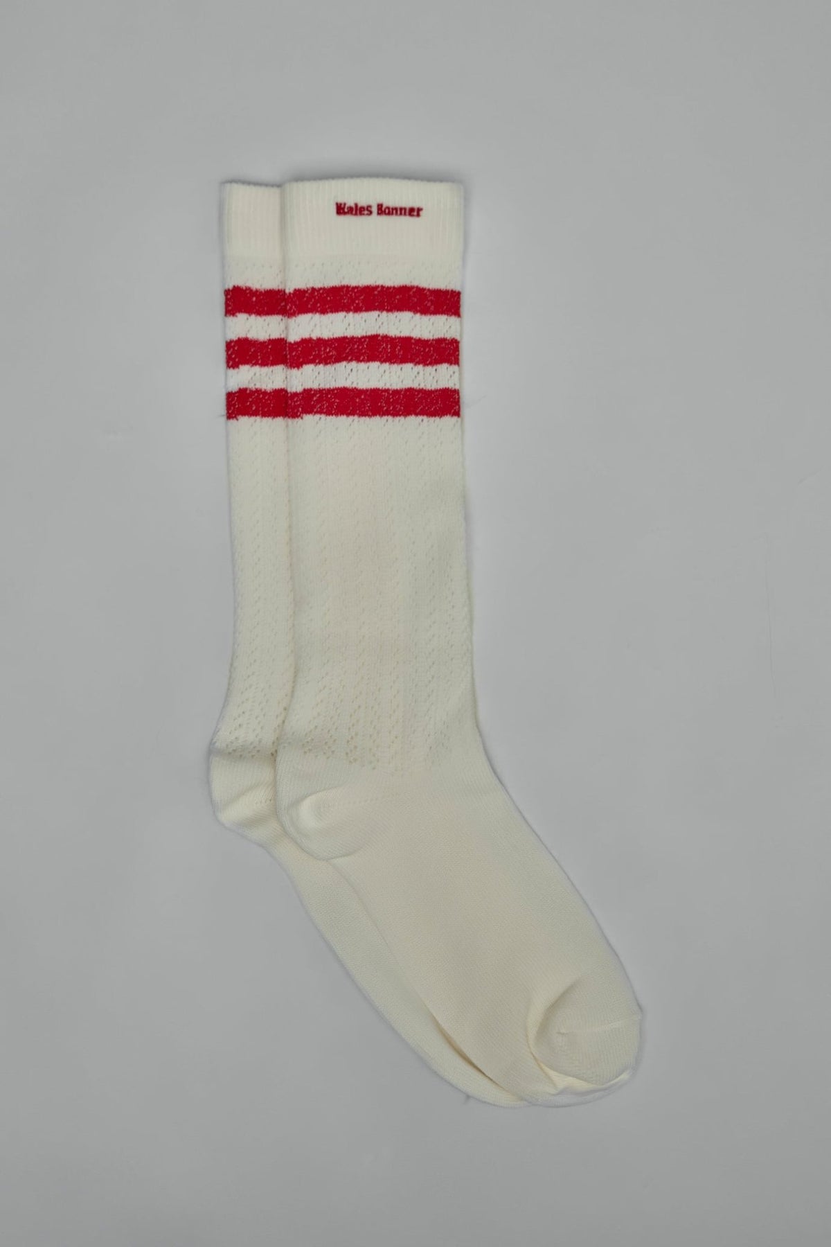Luxury athletic socks featuring high-cut silhouette and contrast logos