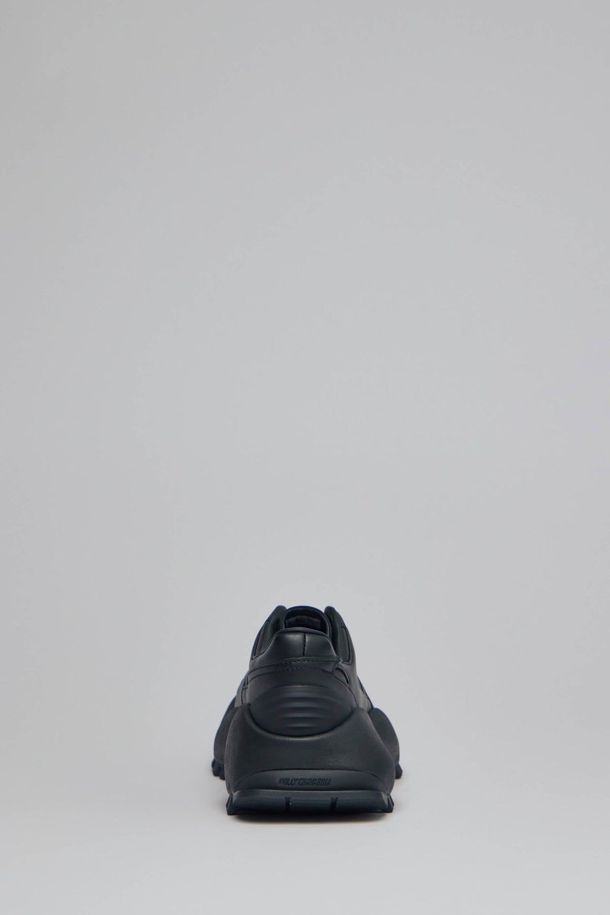 Front view of black leather Adidas x Willy Chavarria collaborative sneaker