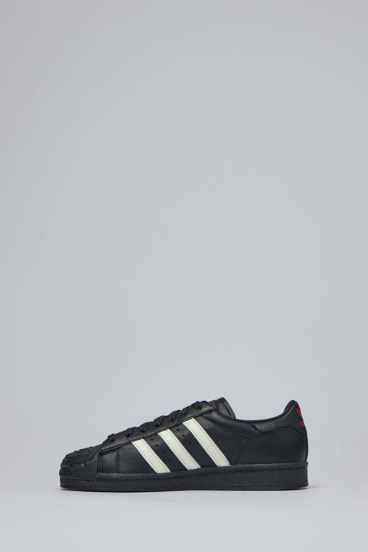 Close-up of embossed rose artwork on toe of Adidas x Willy Chavarria sneakers