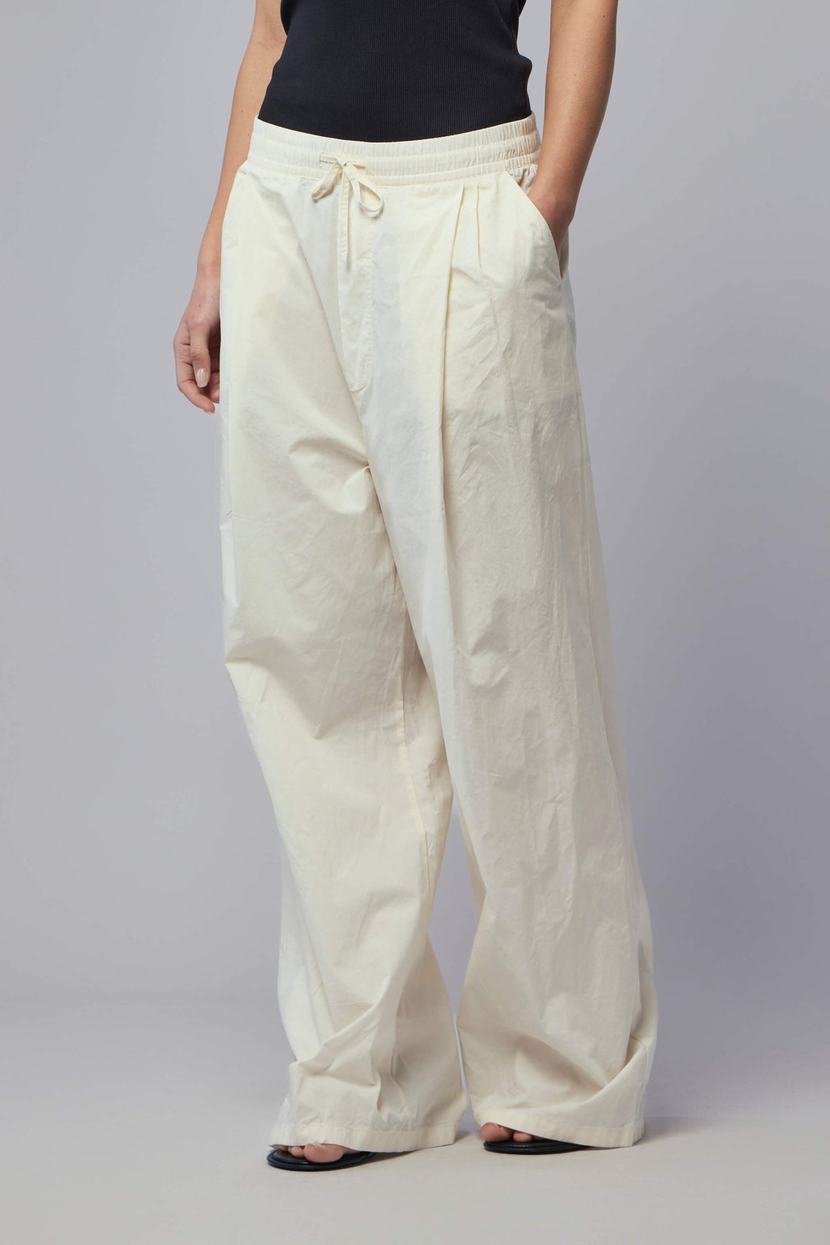 Close-up detail of drawstring waistband on Adnym cotton pants