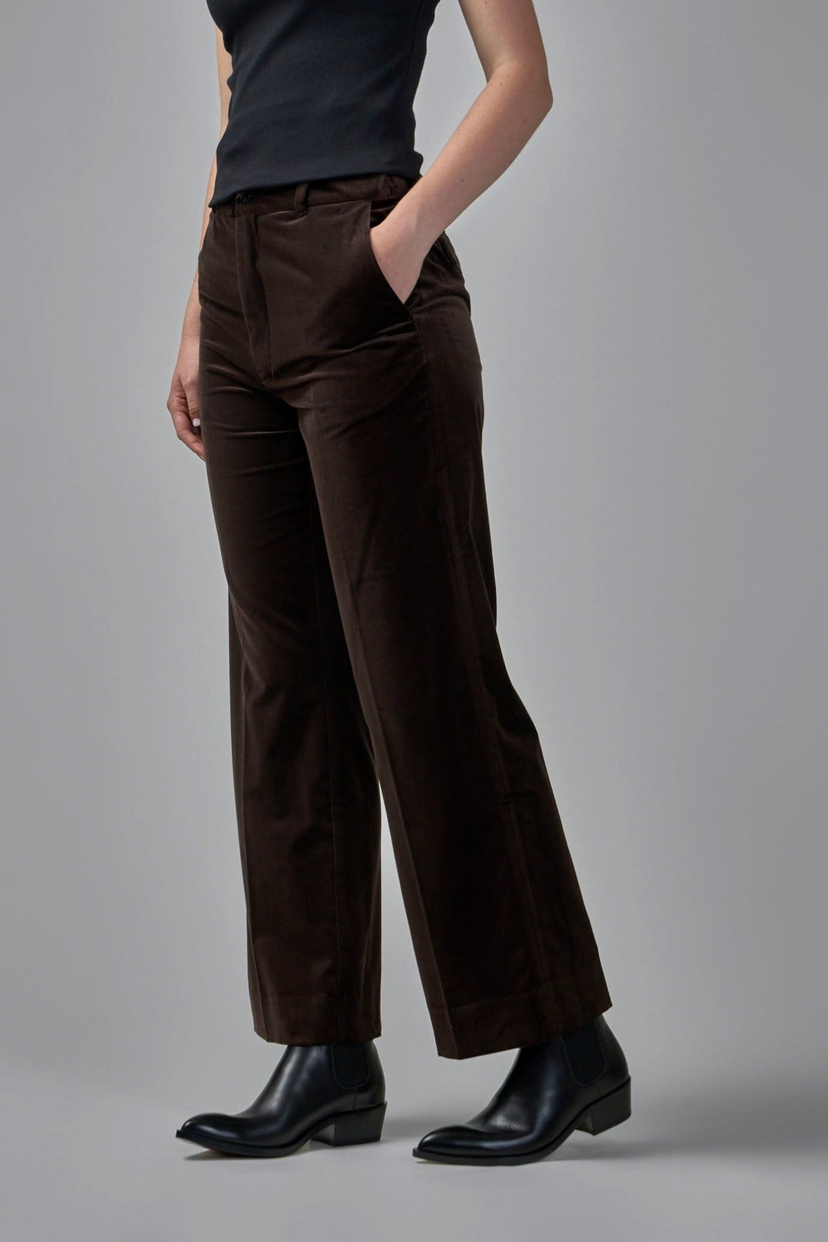 Side view of dark brown straight leg trousers with angled pockets