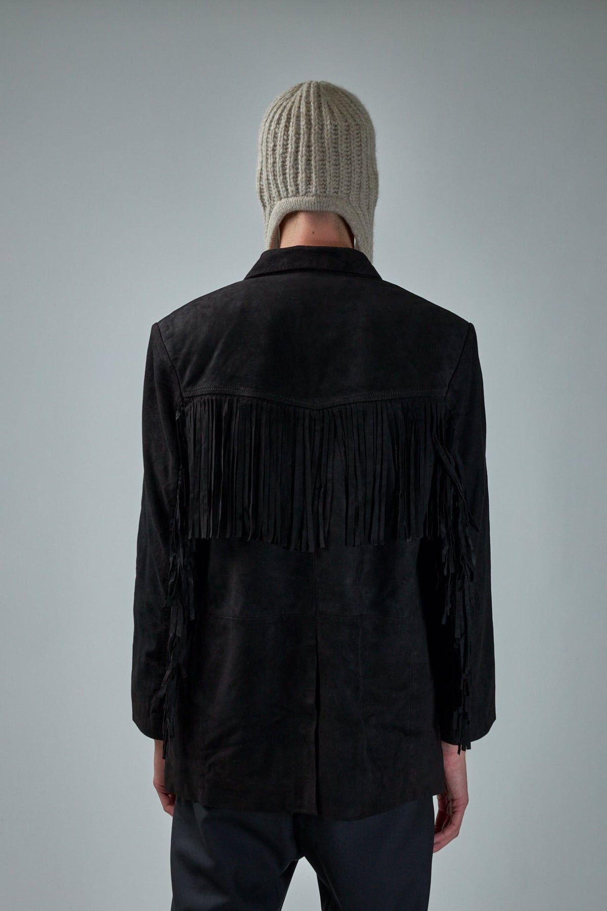 Side view of Rash Fringe Jacket showing welt pockets and tailored silhouette