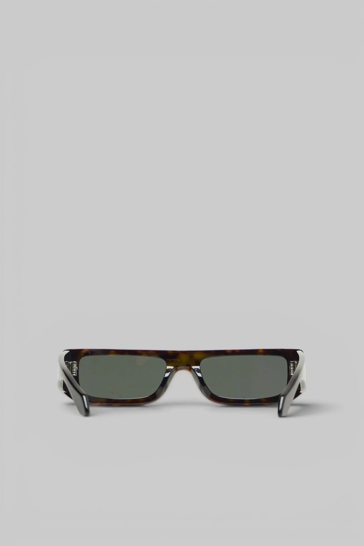 Close-up of brown tinted lenses on Alaïa Sunglasses