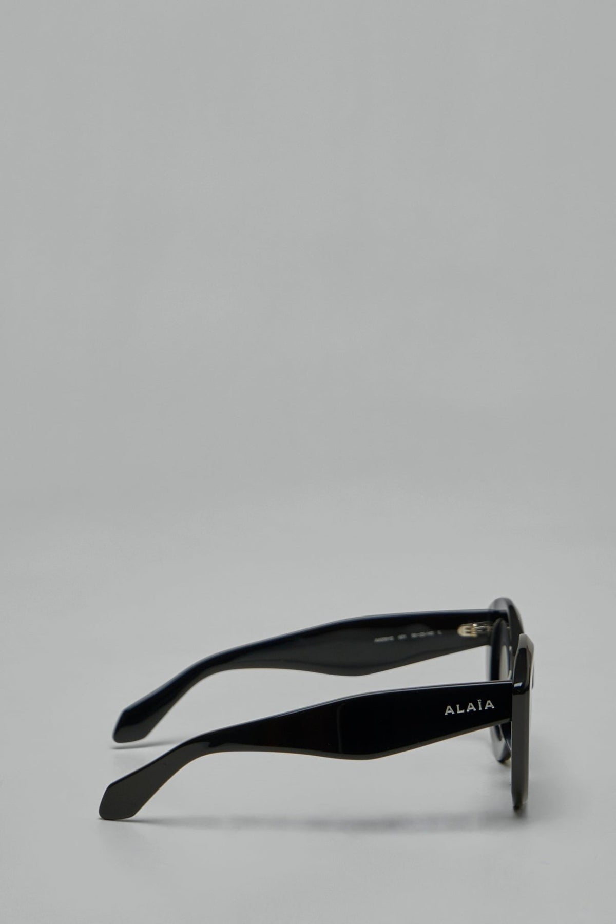 Side view of cat-eye sunglasses with visible ALAÏA branding