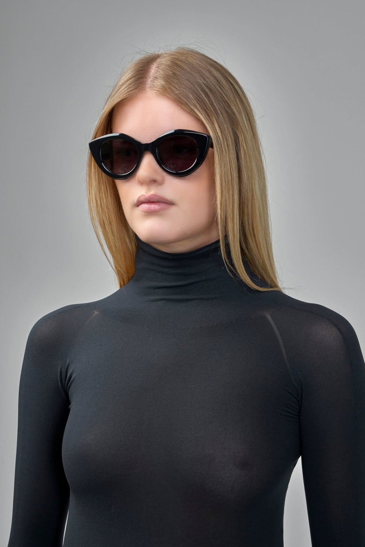 Close-up of Alaïa sunglasses showing chunky tapered temple arms