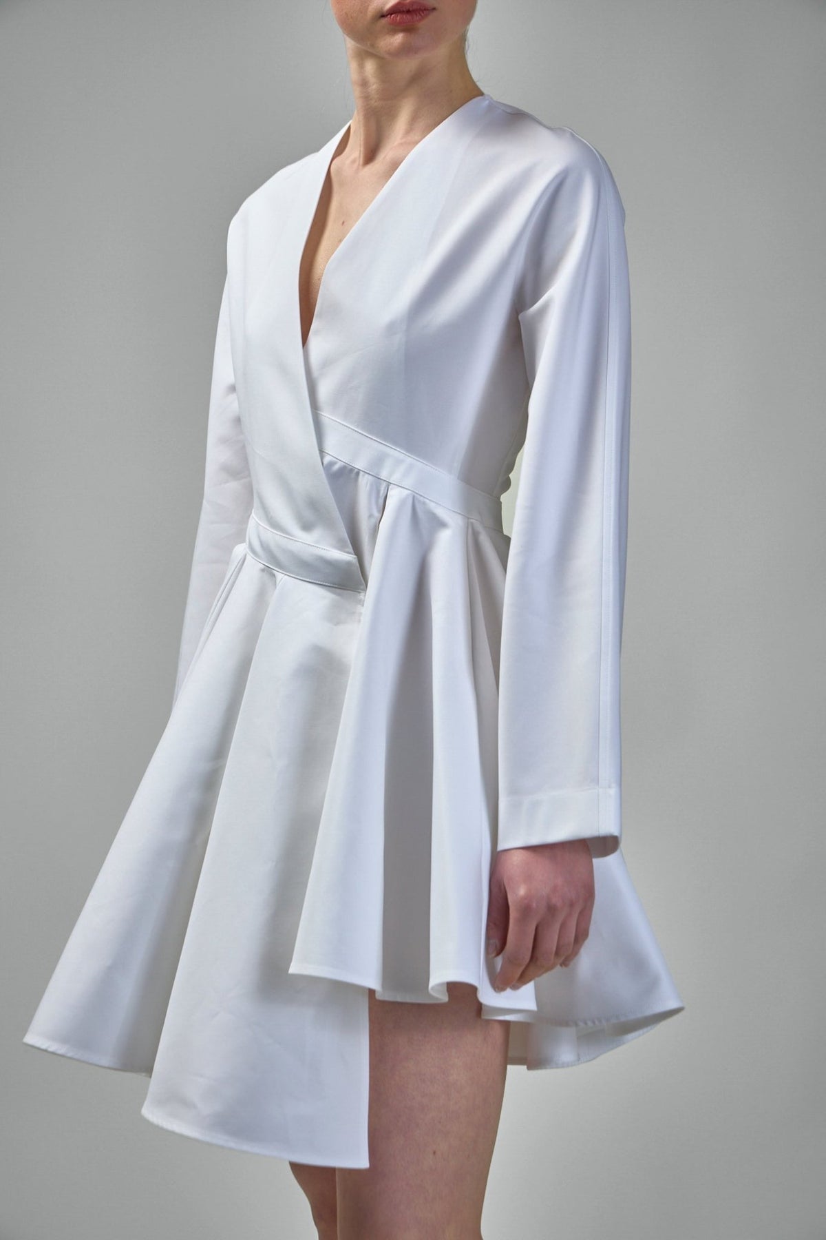 Back view of Alaïa asymmetric belt dress in premium white cotton poplin