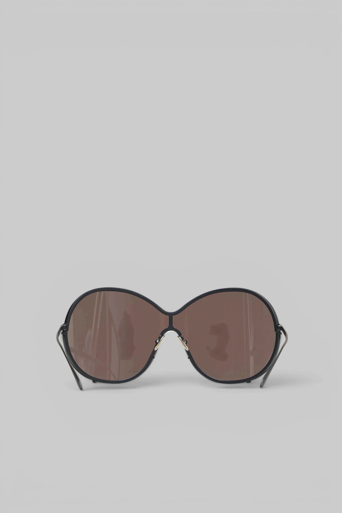 Close-up of metallic hinge accents on Alaïa Sunglasses
