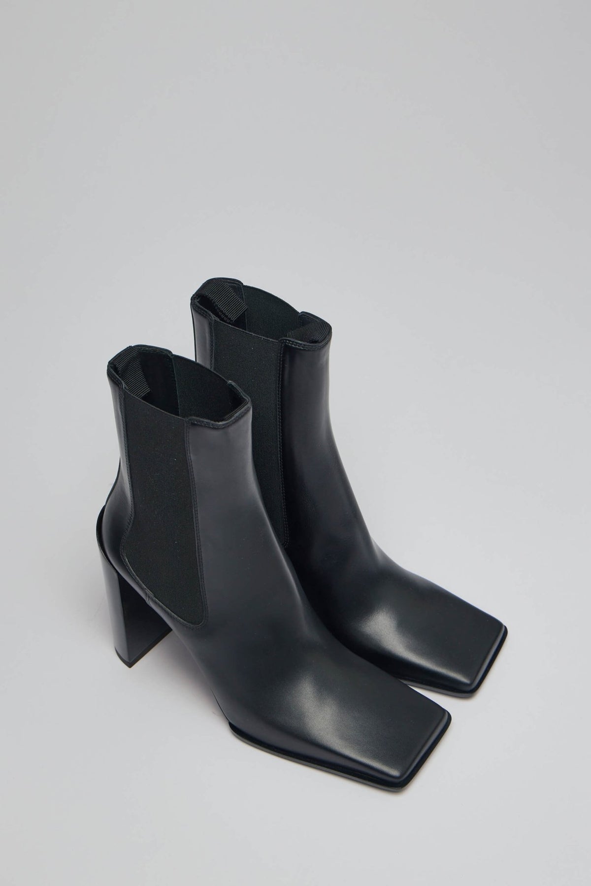 Close-up view of Alaïa Chelsea boots showing square toe design