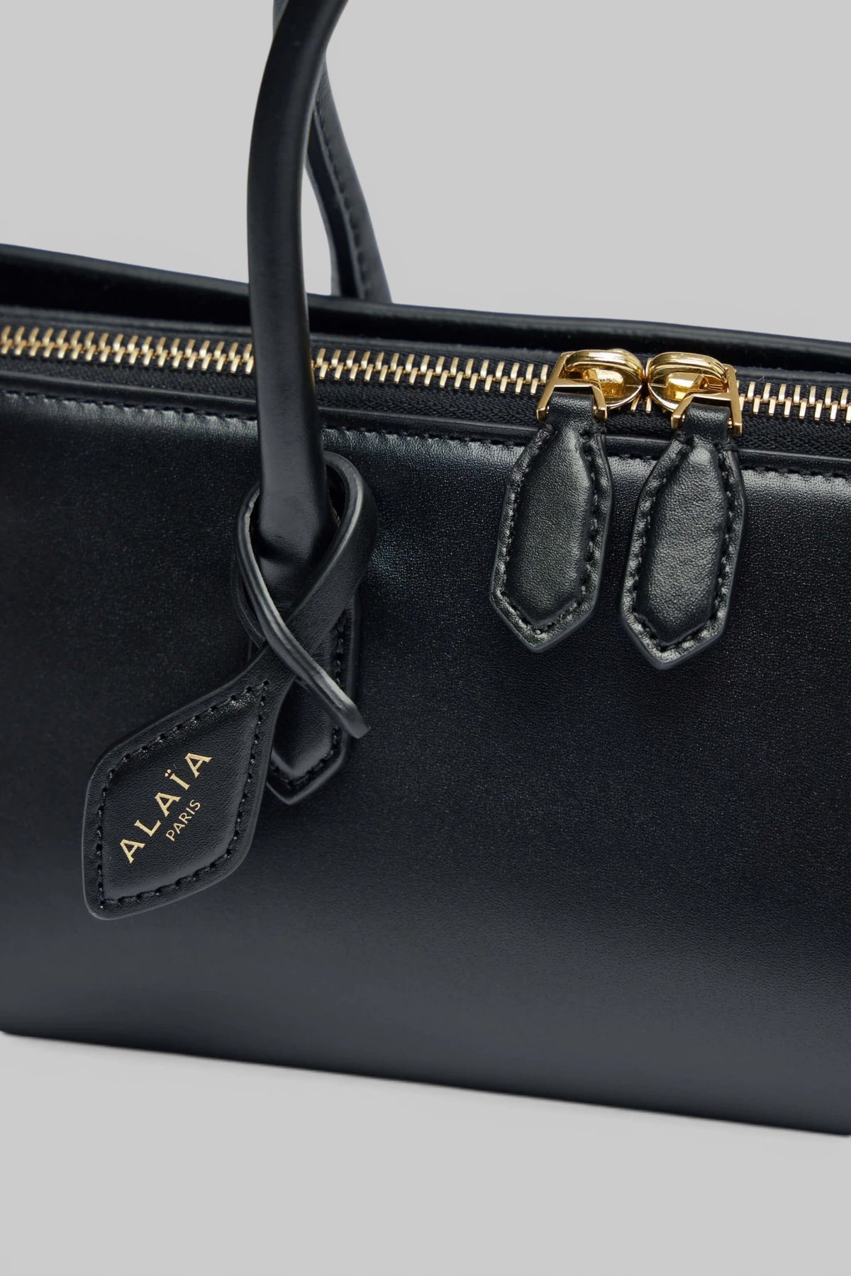 Alaïa Delta Small handbag carried by model, lifestyle shot