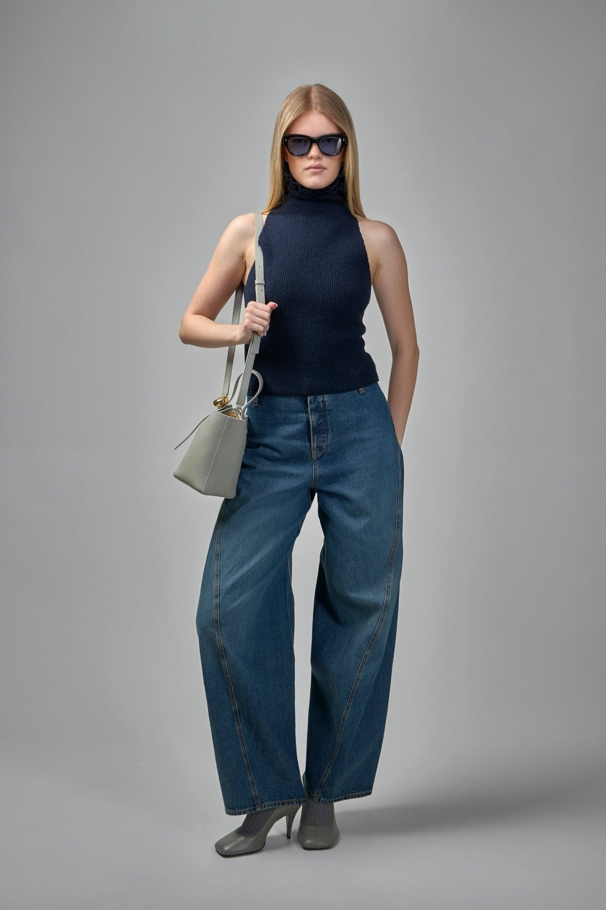 Detail of fine textured knit surface and armhole cut