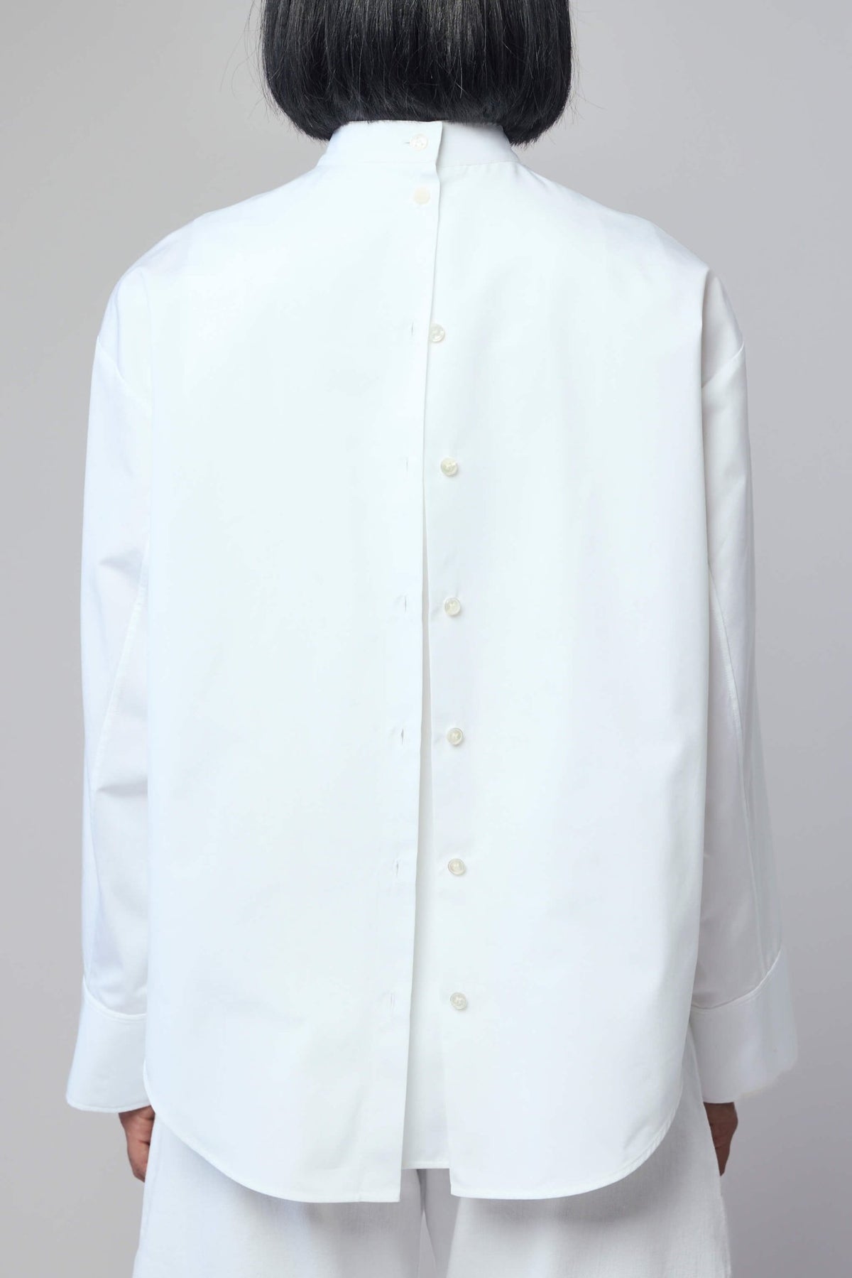 Full outfit styling with Alaïa layered cotton blouse