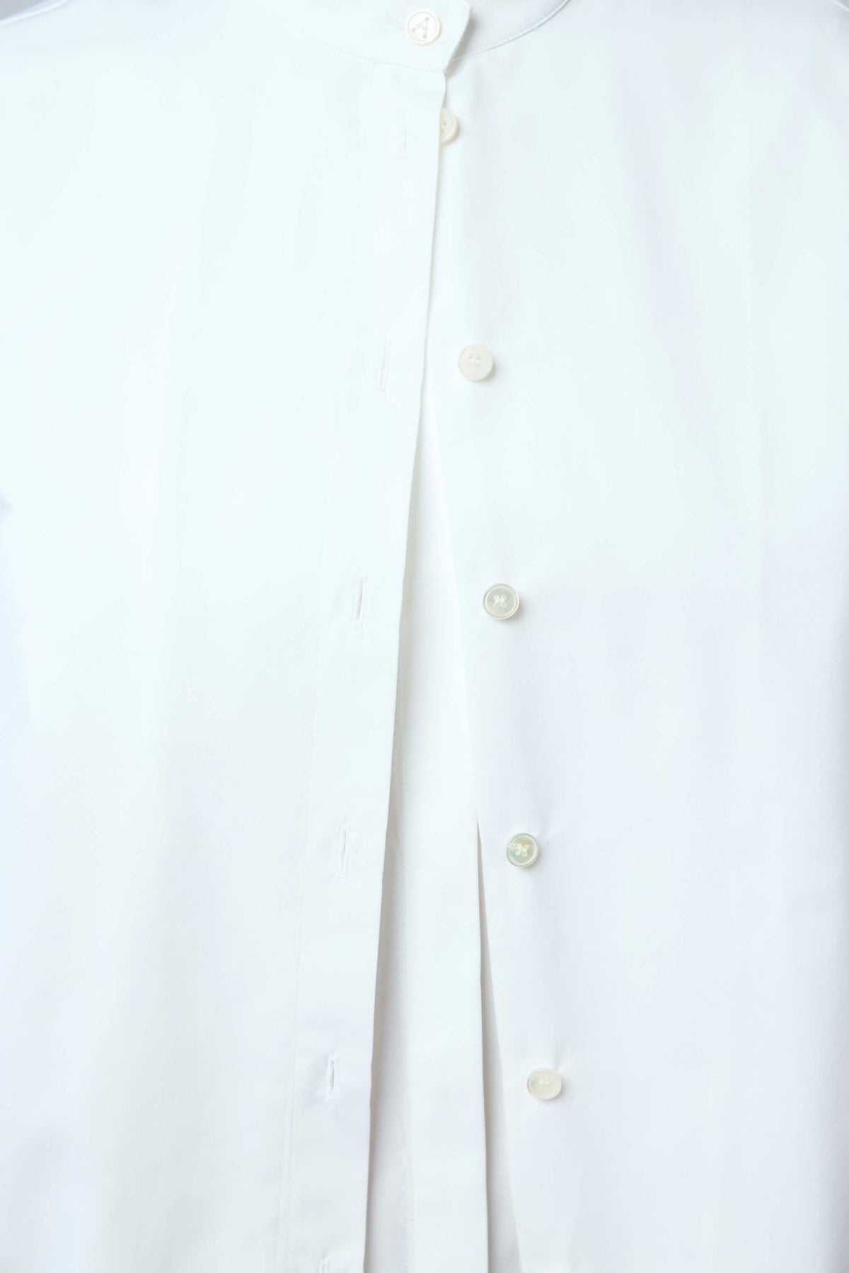Back view of Alaïa white cotton blouse showing clean tailored lines