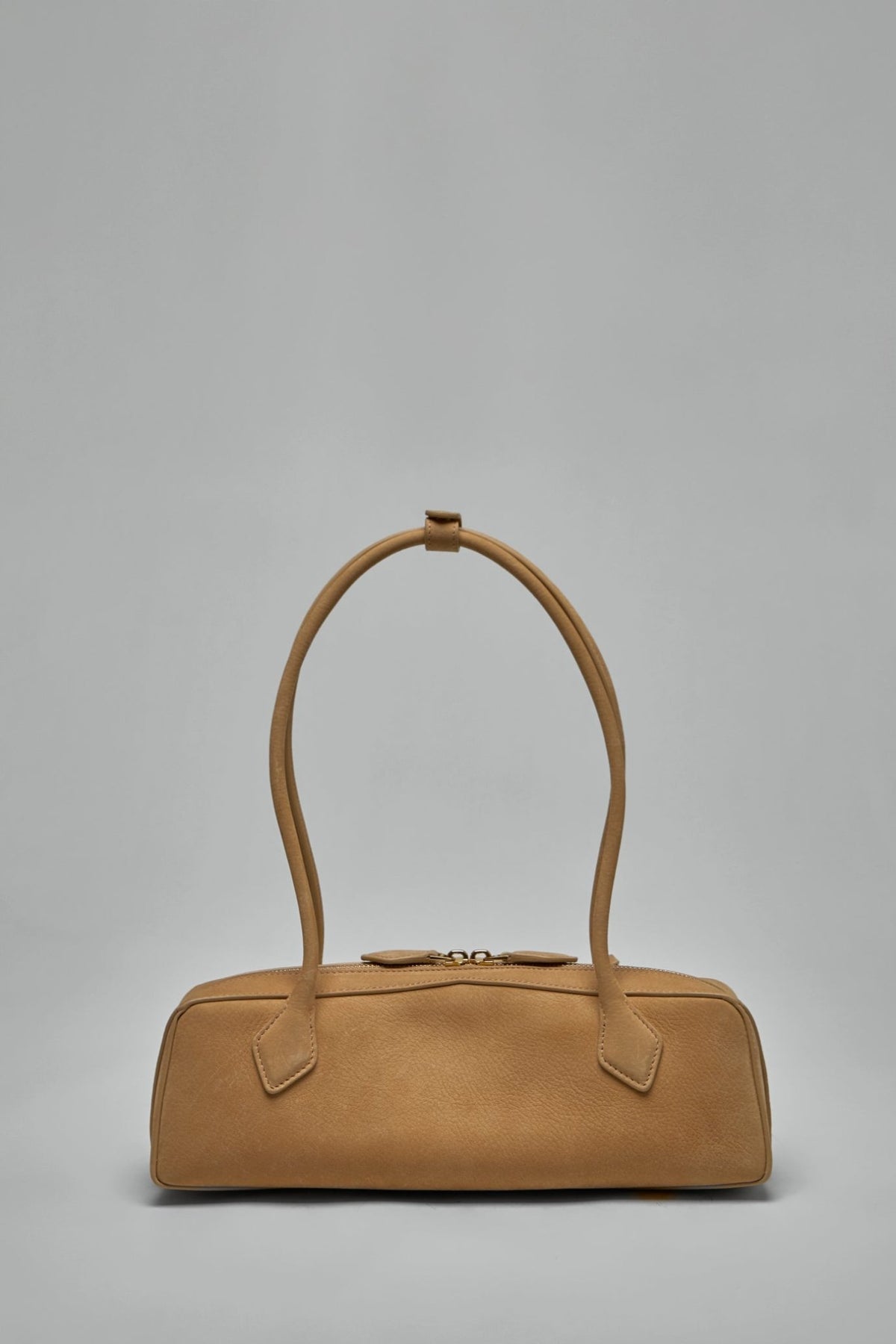 Side view showing structured silhouette and double rounded straps