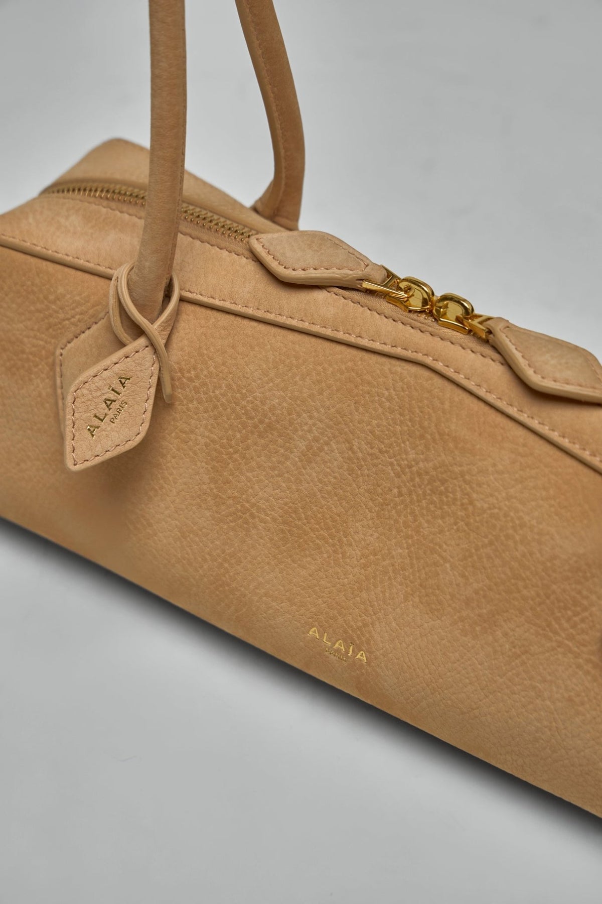 Gold-tone hardware detail and embossed Alaïa logo