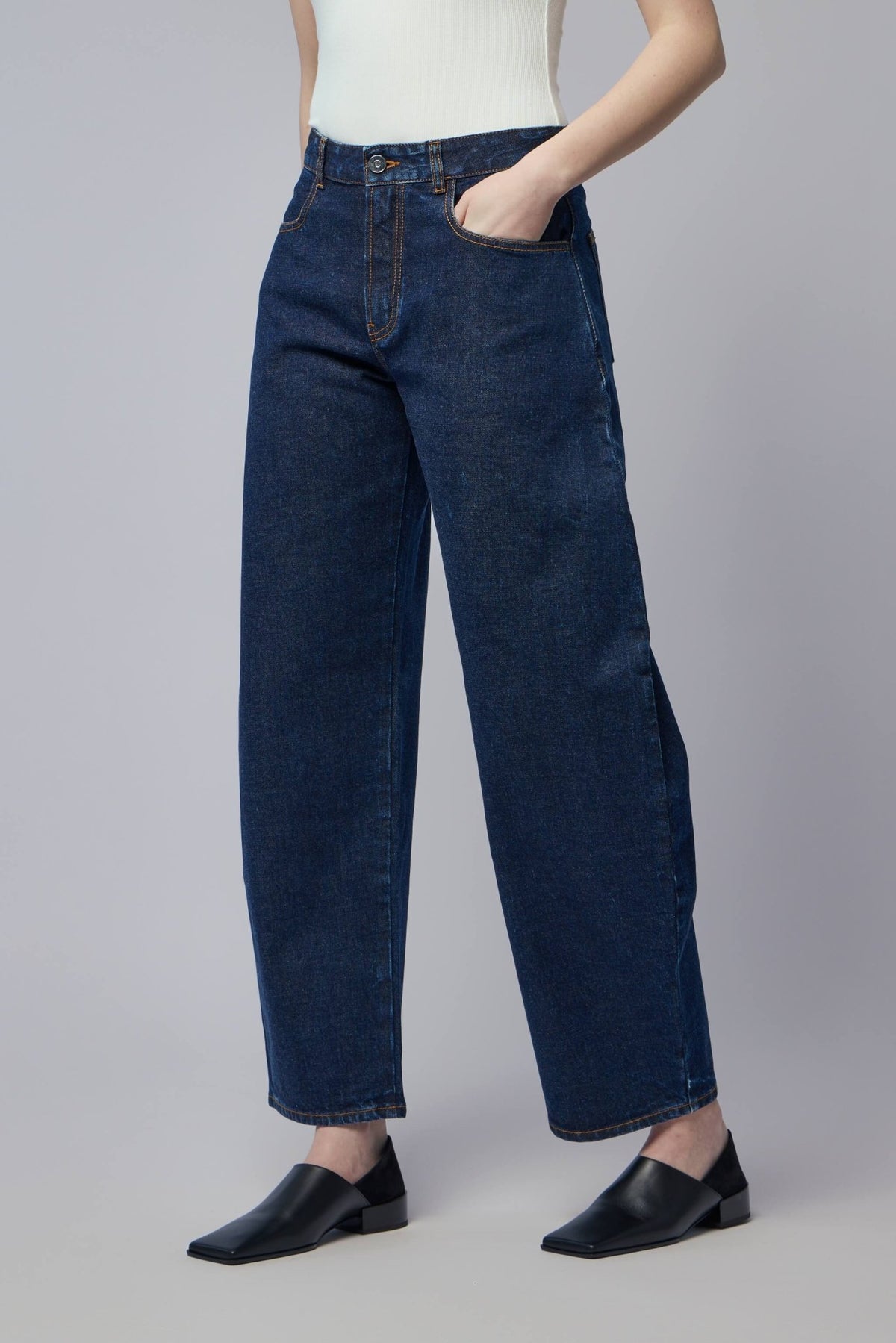 Close-up detail of Alaïa denim pants showing premium cotton construction