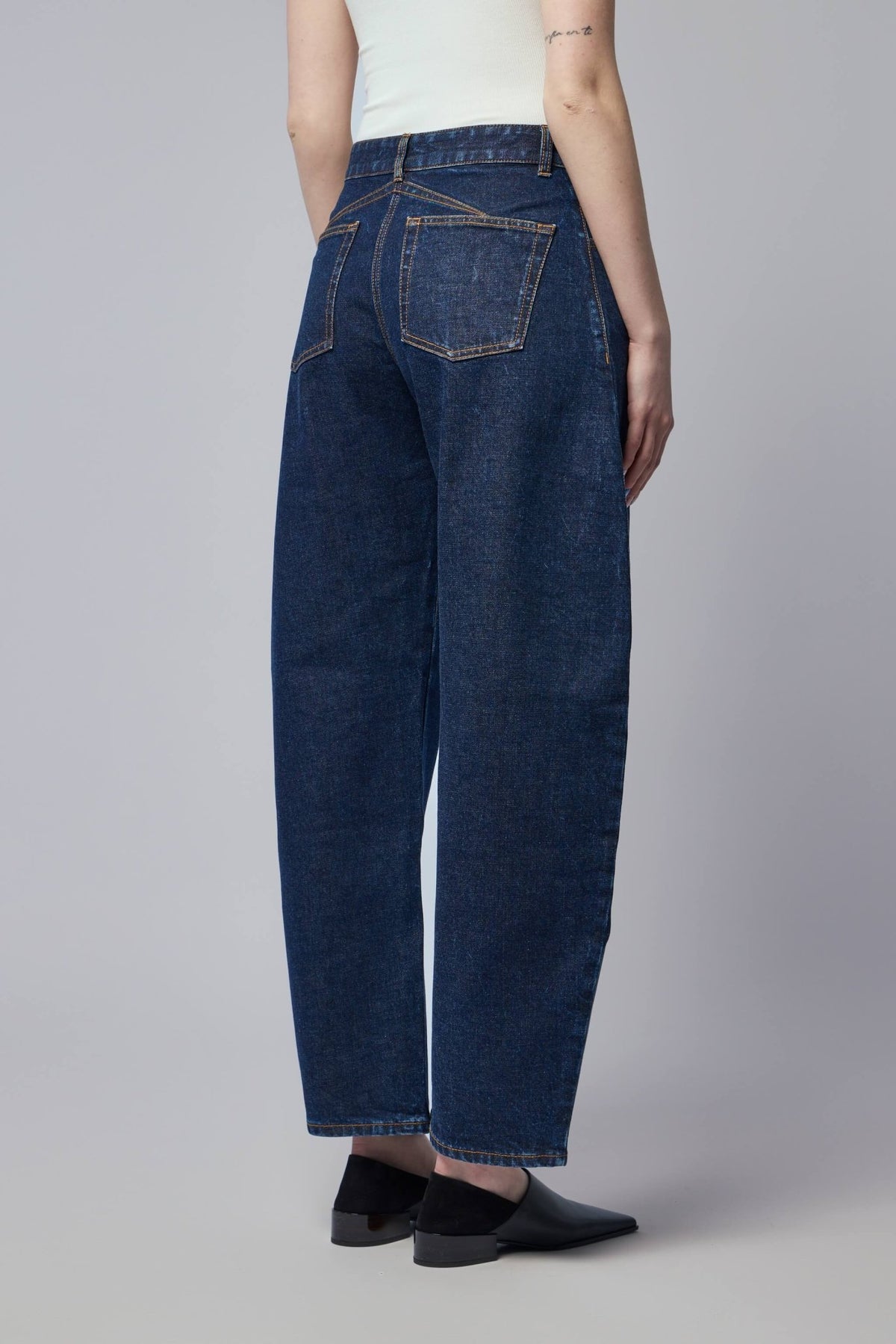 Back view of Alaïa wide-leg pants highlighting classic five-pocket design