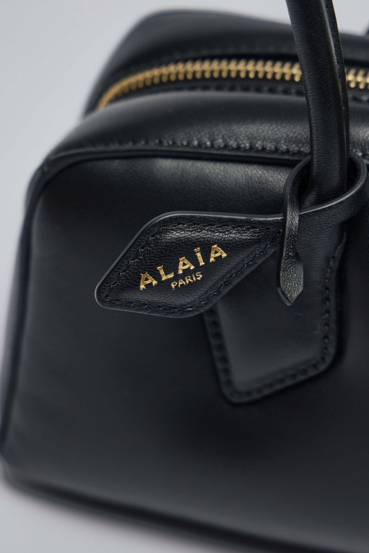 Model carrying Alaïa Le Teckel medium bag demonstrating size and proportions