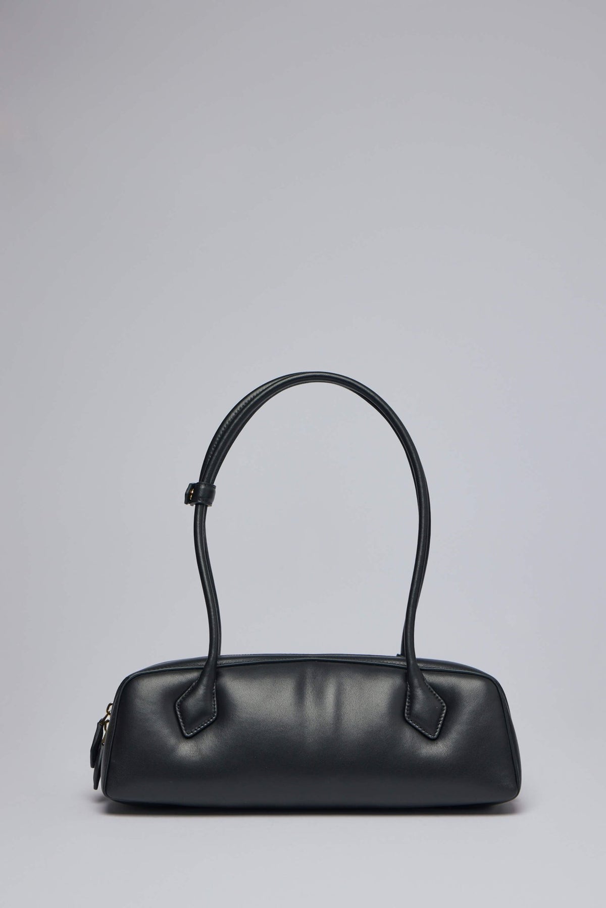 Side profile of Alaïa medium shoulder bag with dual handles