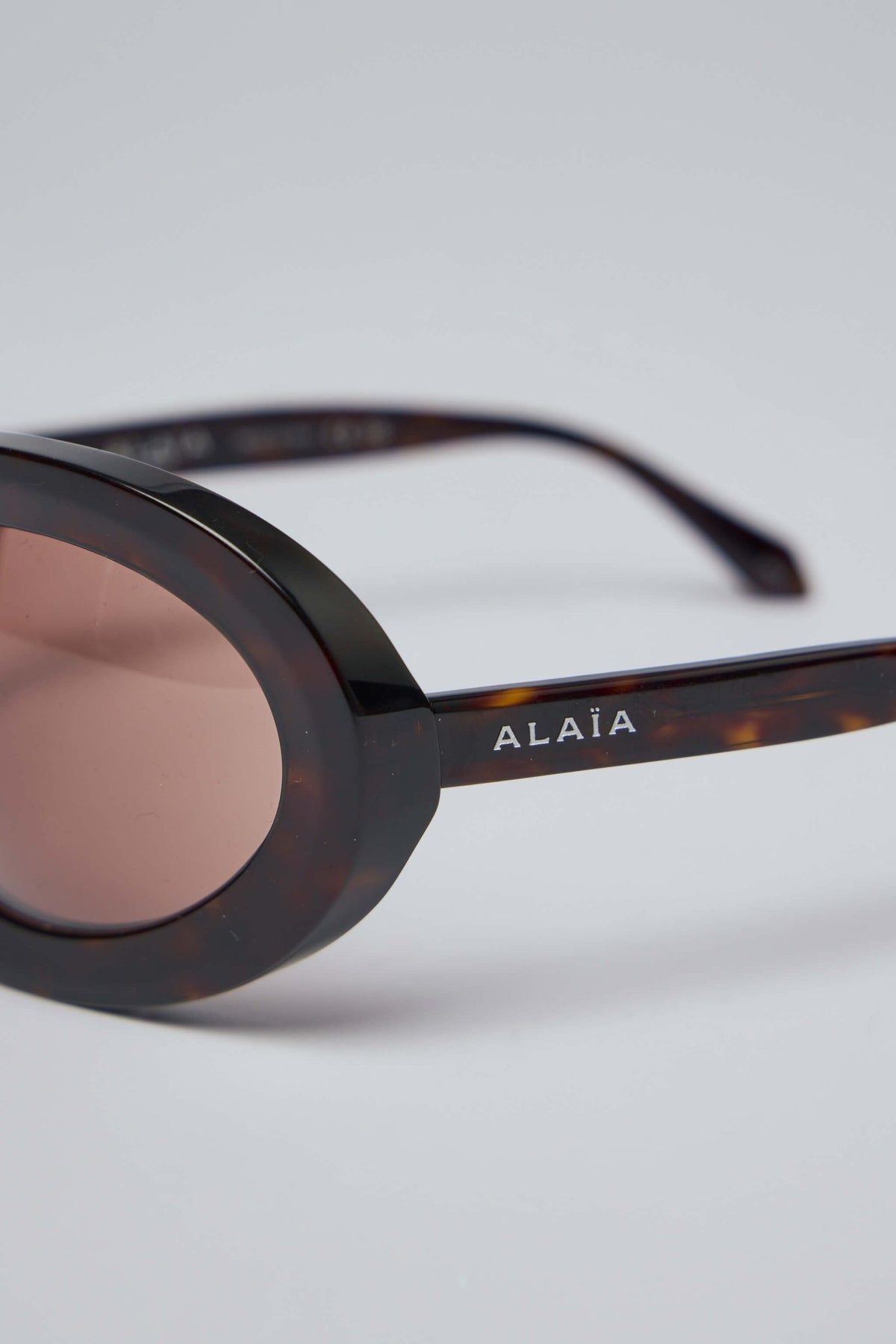 Side profile of Alaïa sunglasses displaying subtle brand logo detailing