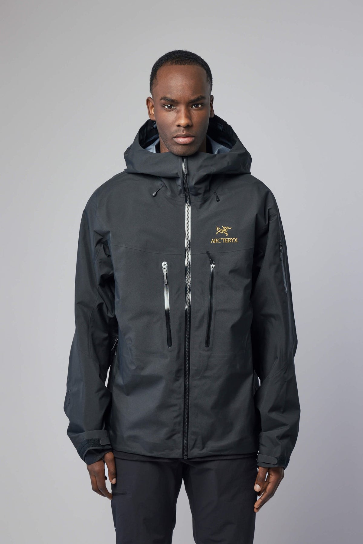 Close-up of ARC'TERYX Alpha Sv jacket chest zip pockets and logo detail