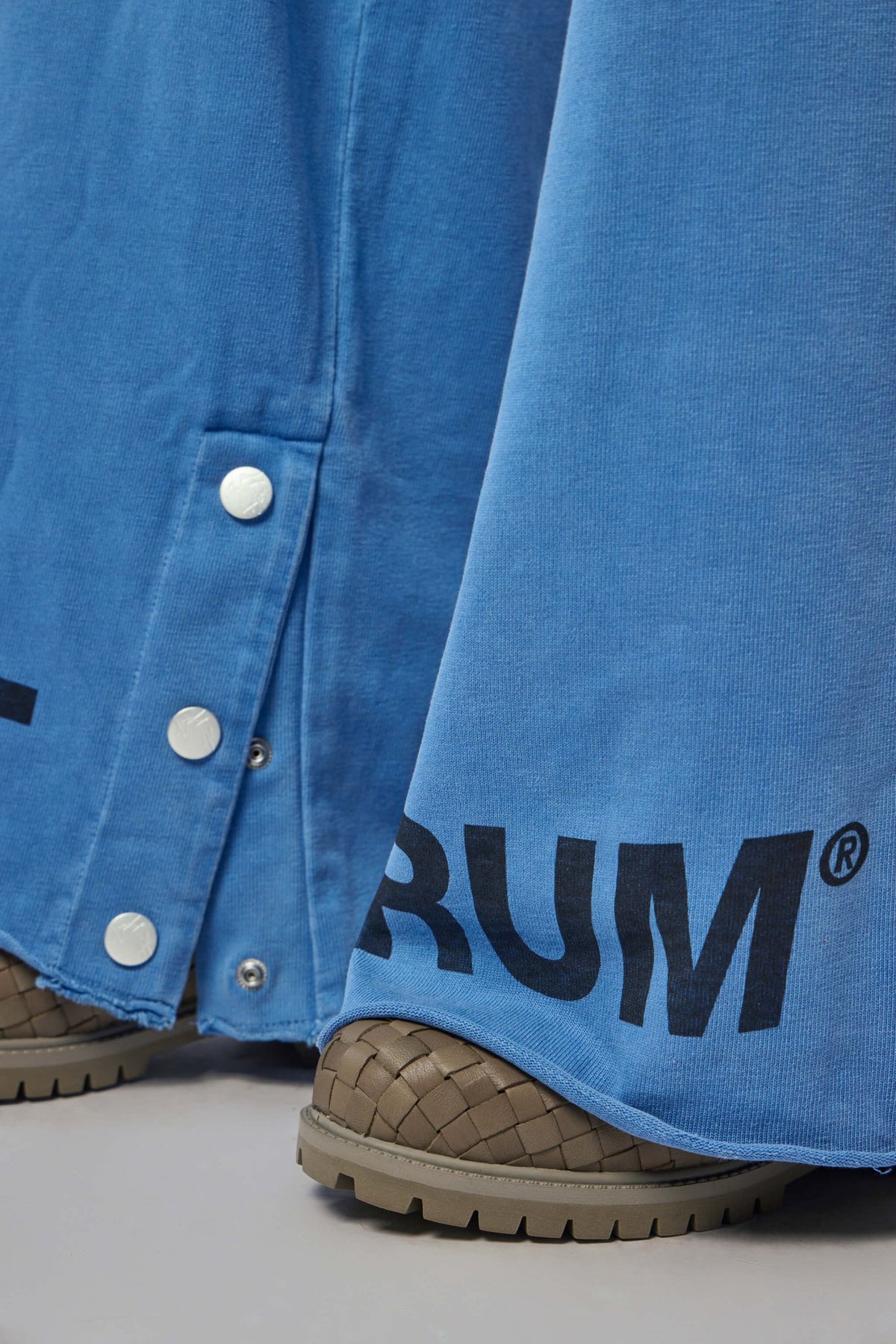 Detail shot of side pockets on bright blue cotton track pants