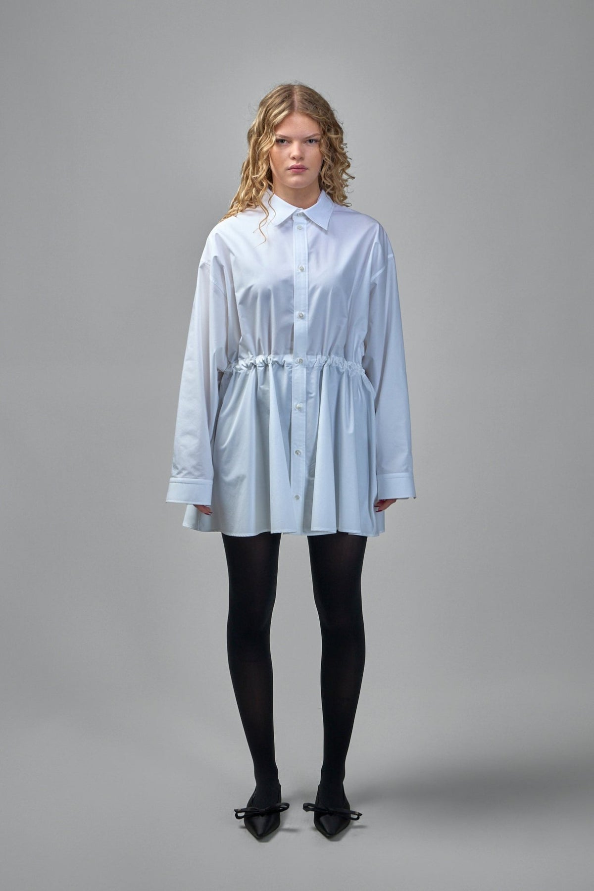 Close-up view of Balenciaga shirt dress showing button-down front and collar details