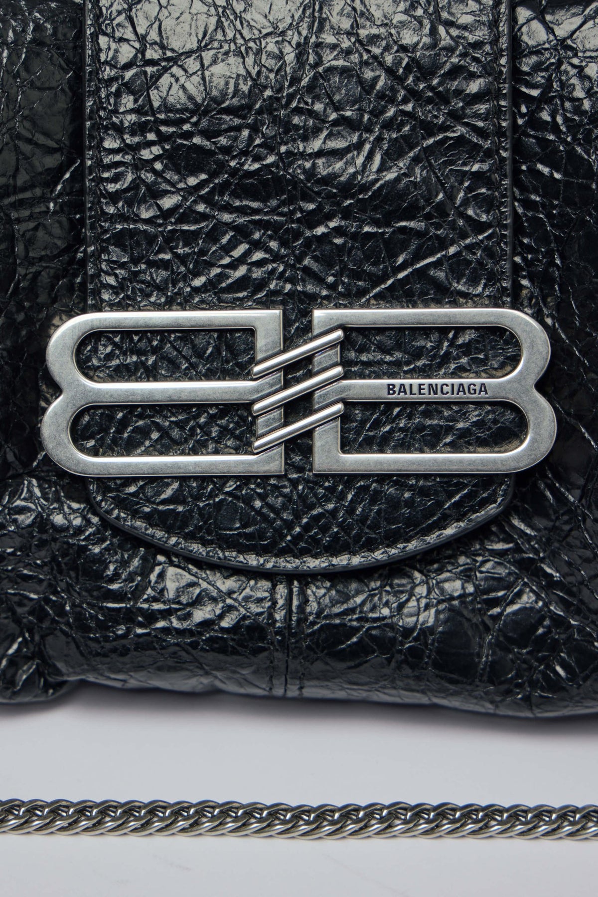 Detail shot of metallic chain strap and leather construction on Pamela bag