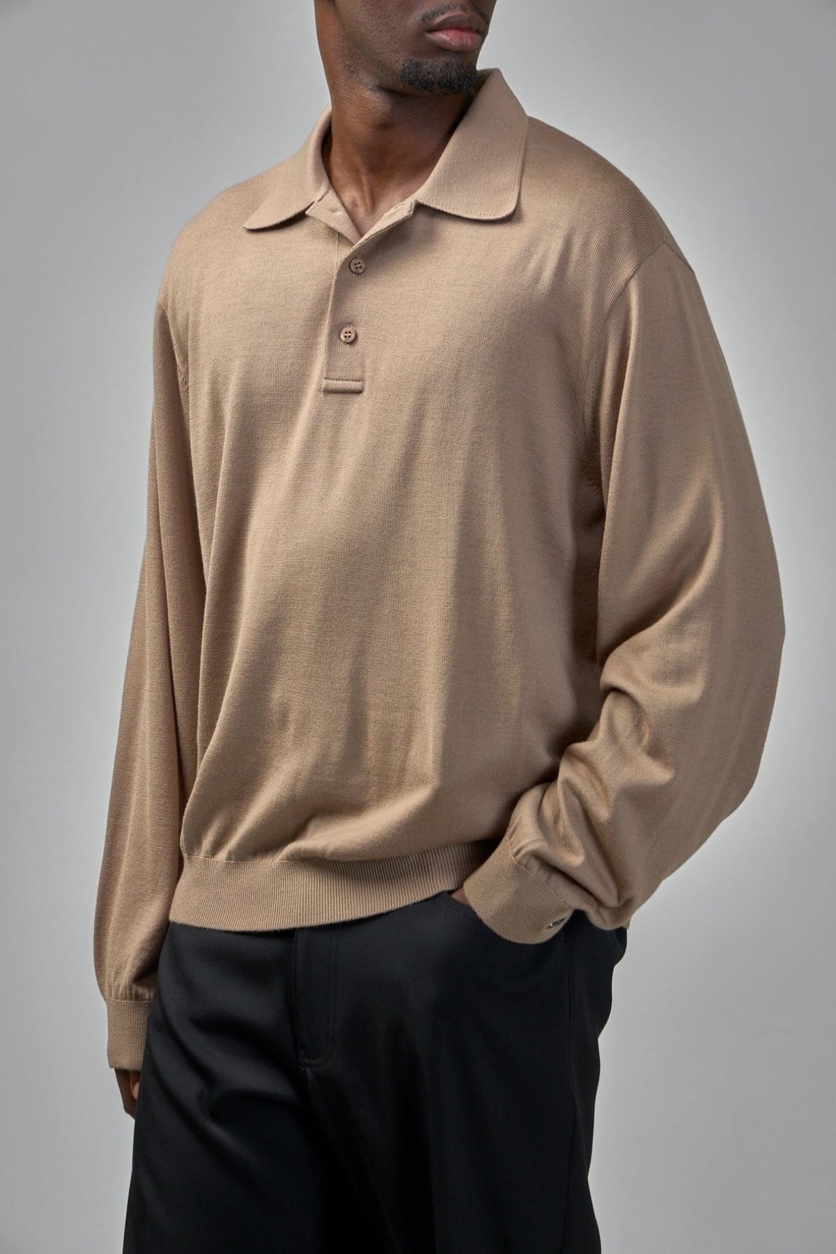 Detail shot of three-button placket on Balenciaga beige knitwear sweater