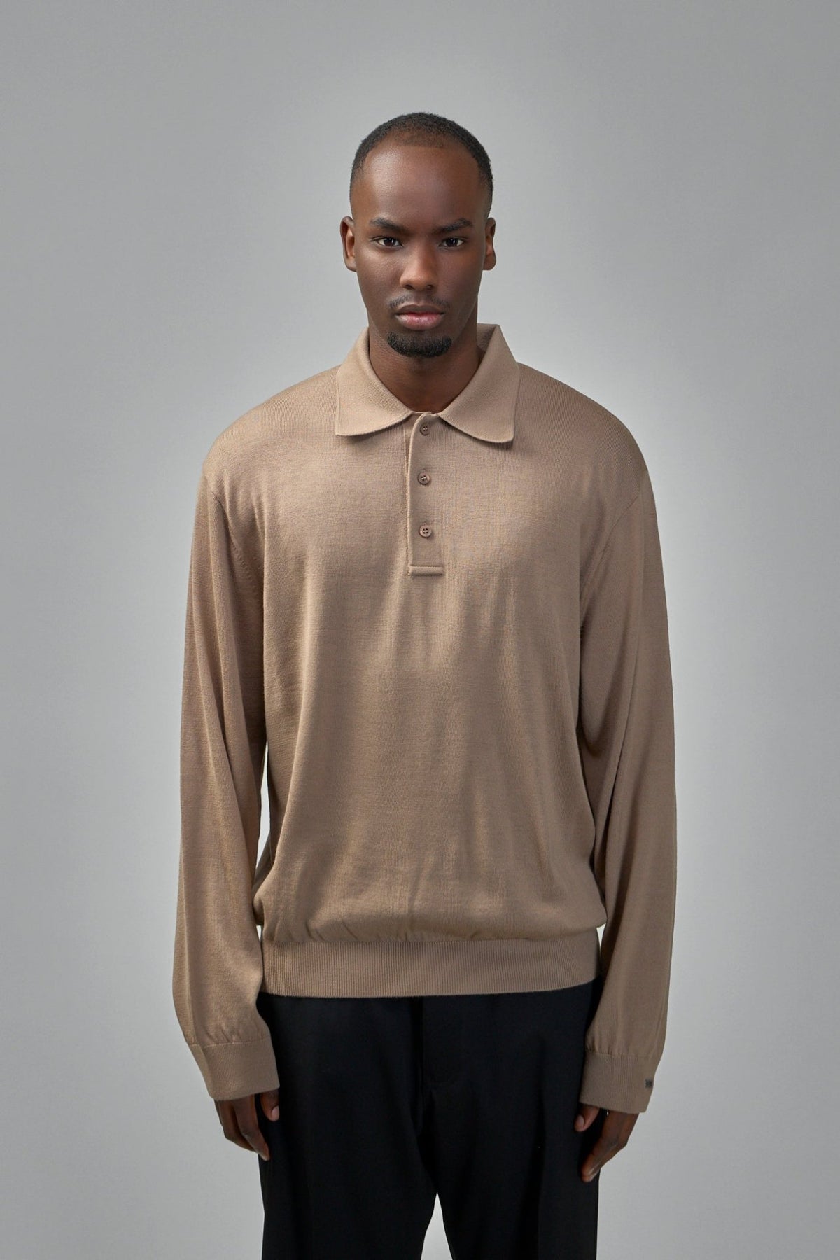 Close-up of Balenciaga poloneck sweater showing ribbed cuffs and soft wool texture