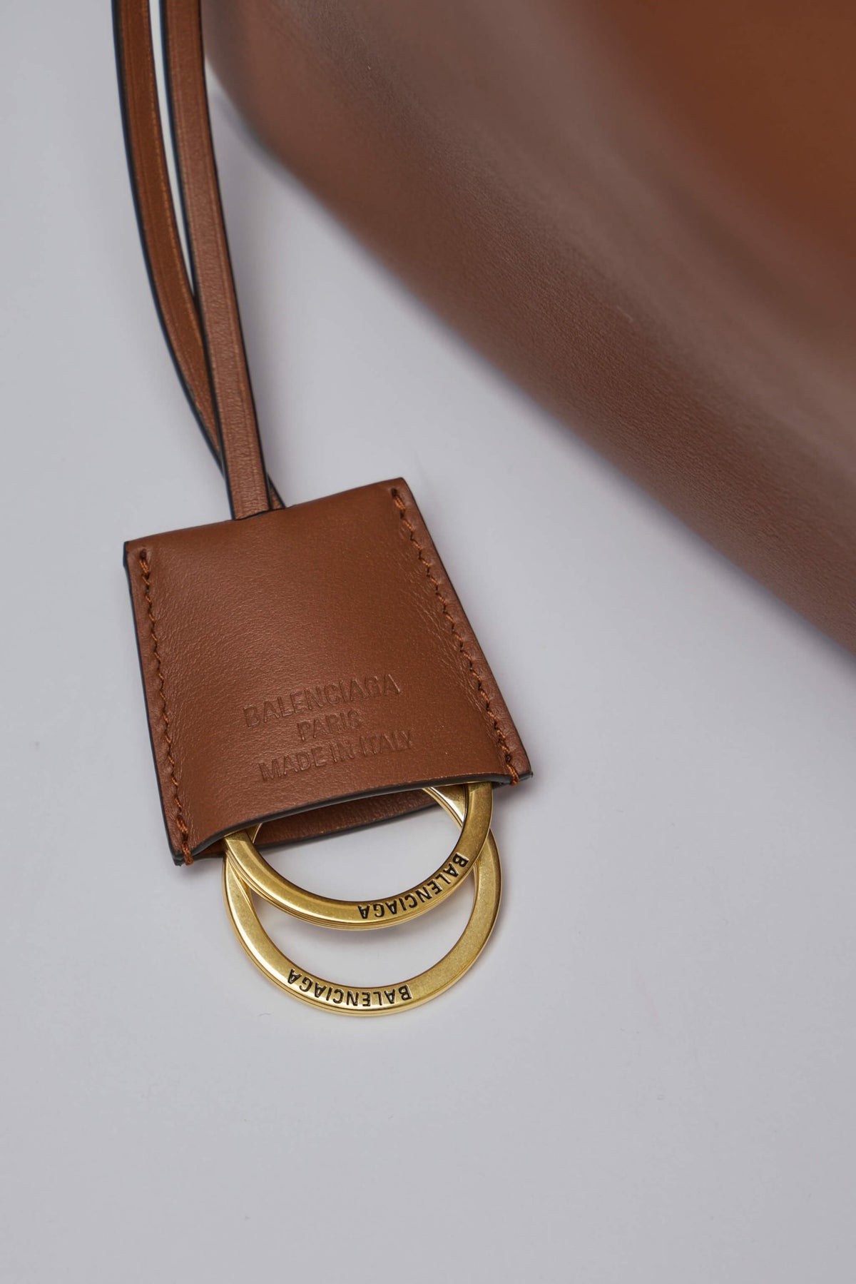 Balenciaga tote bag styled with luxury accessories on neutral background