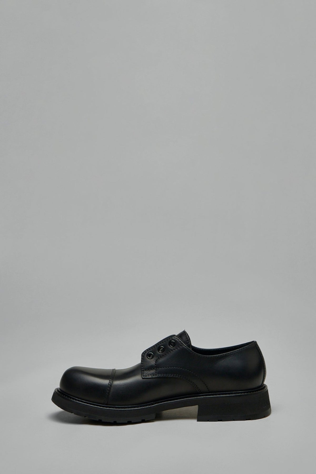 Side view of black leather Balenciaga flats with rounded toe