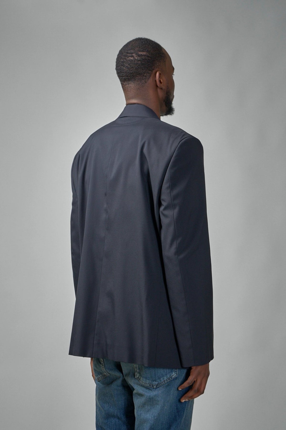 Close-up of Balenciaga blazer showing notch lapel and two-button closure detail