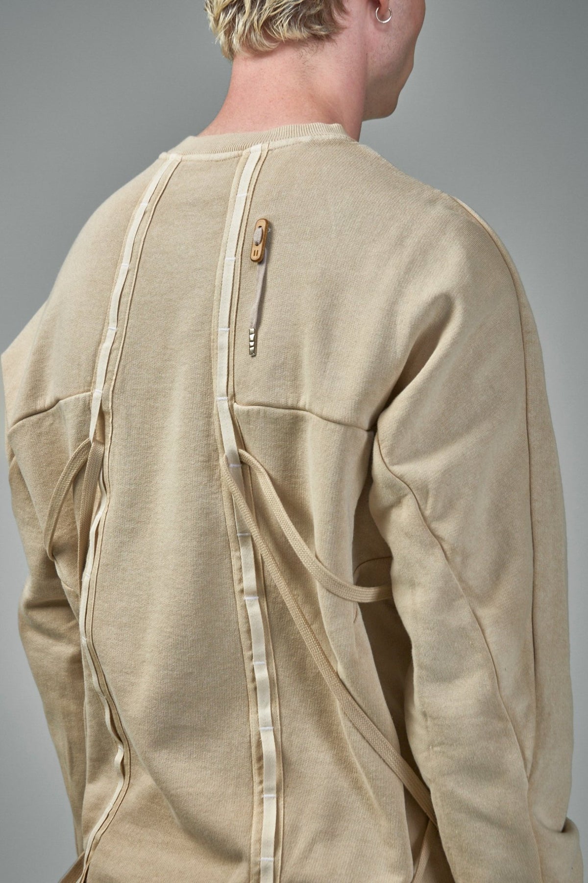 Full view of minimalist Pull5 sweater showcasing architectural silhouette