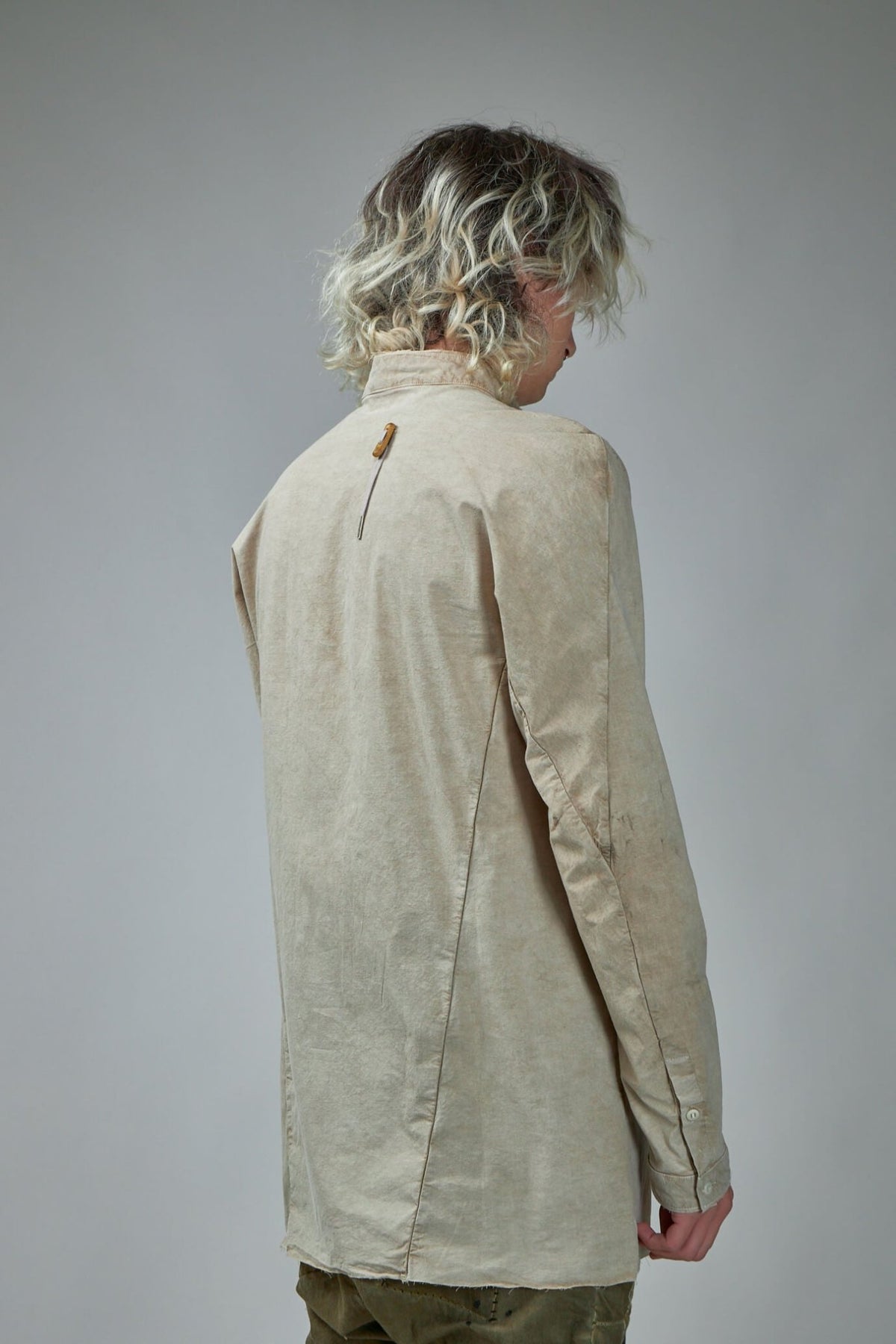 Back view of SHIRT1 featuring signature drawstring detailing