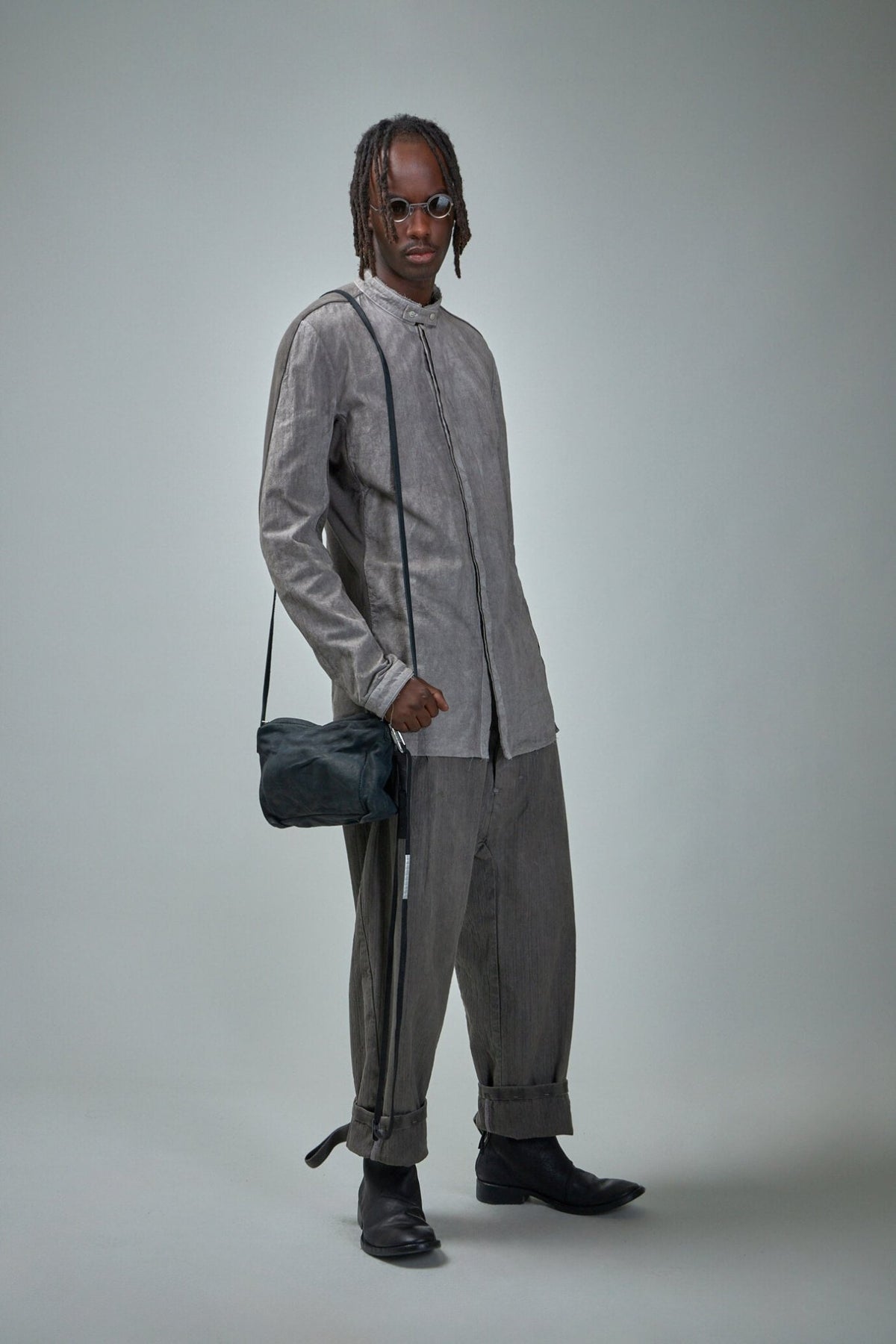 Close-up view of carbon grey cotton shirt showing buttoned cuffs detail